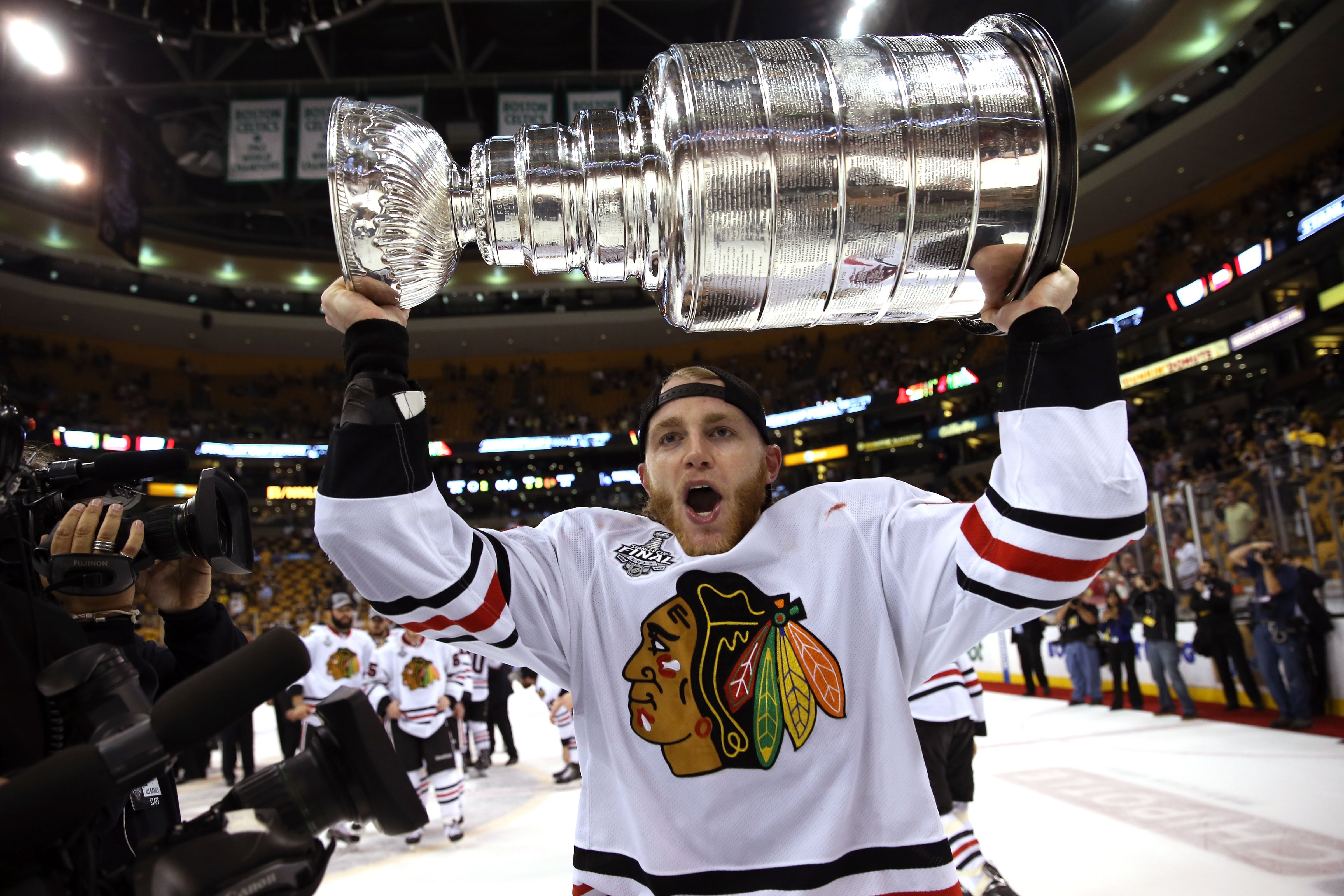 Patrick Kane #88 of the Chicago Blackhawks celebrates with the Stanley Cup after they won 3-2 against the Boston Bruins in Game Six of the 2013 NHL Stanley Cup Final at TD Garden on June 24, 2013 in Boston, Massachusetts. (Bruce Bennett&mdash;Getty Images)