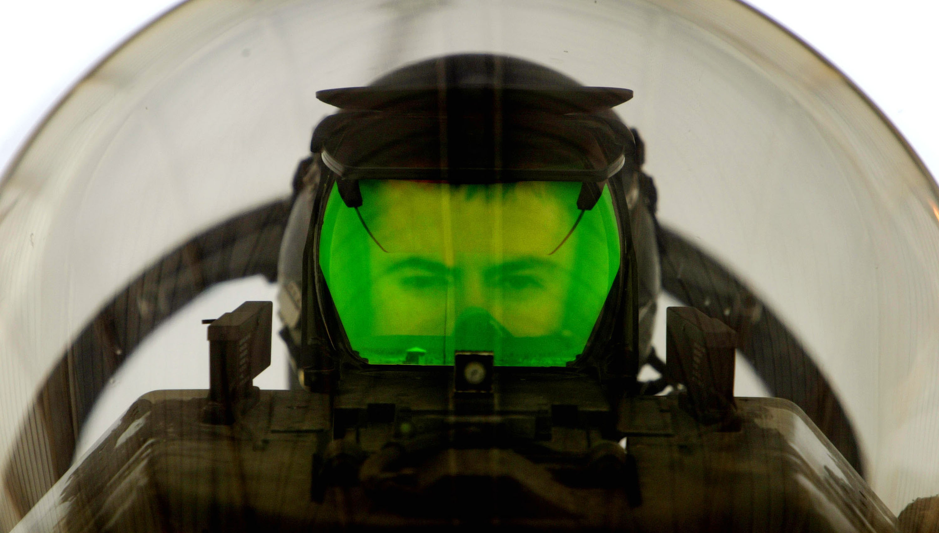 A U.S. Air Force pilot looks through the Heads Up Display (HUD) of his F-16 "Fighting Falcon" as he prepares to deploy on a mission April 2, 2003 at an air base near the Iraqi border. (Ian Waldie&mdash;Getty Images)