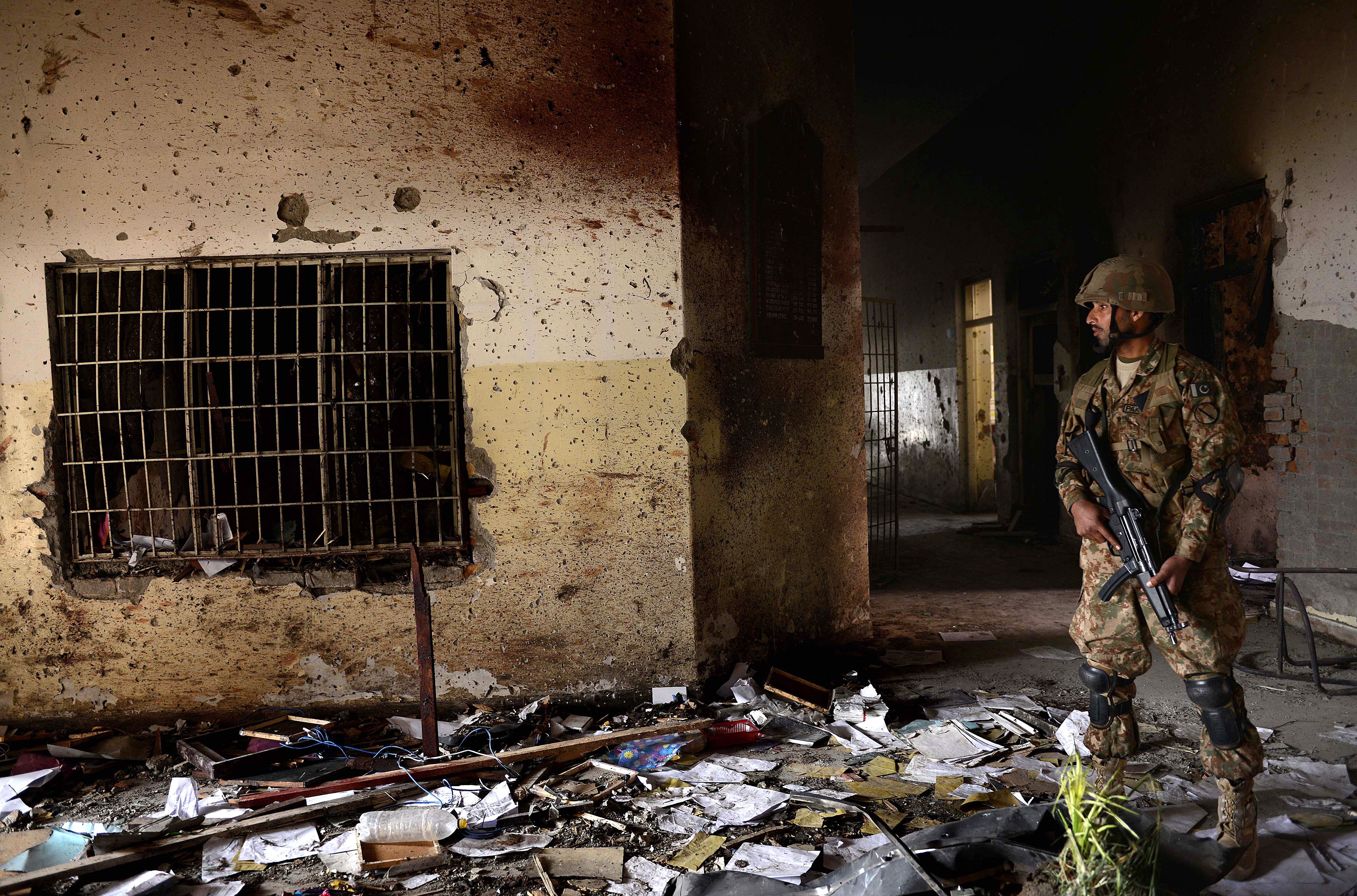 A Pakistani army soldier stands guard at the site of the militants' attack on the army-run school in Peshawar on December 18, 2014. (A MAJEED—AFP/Getty Images)