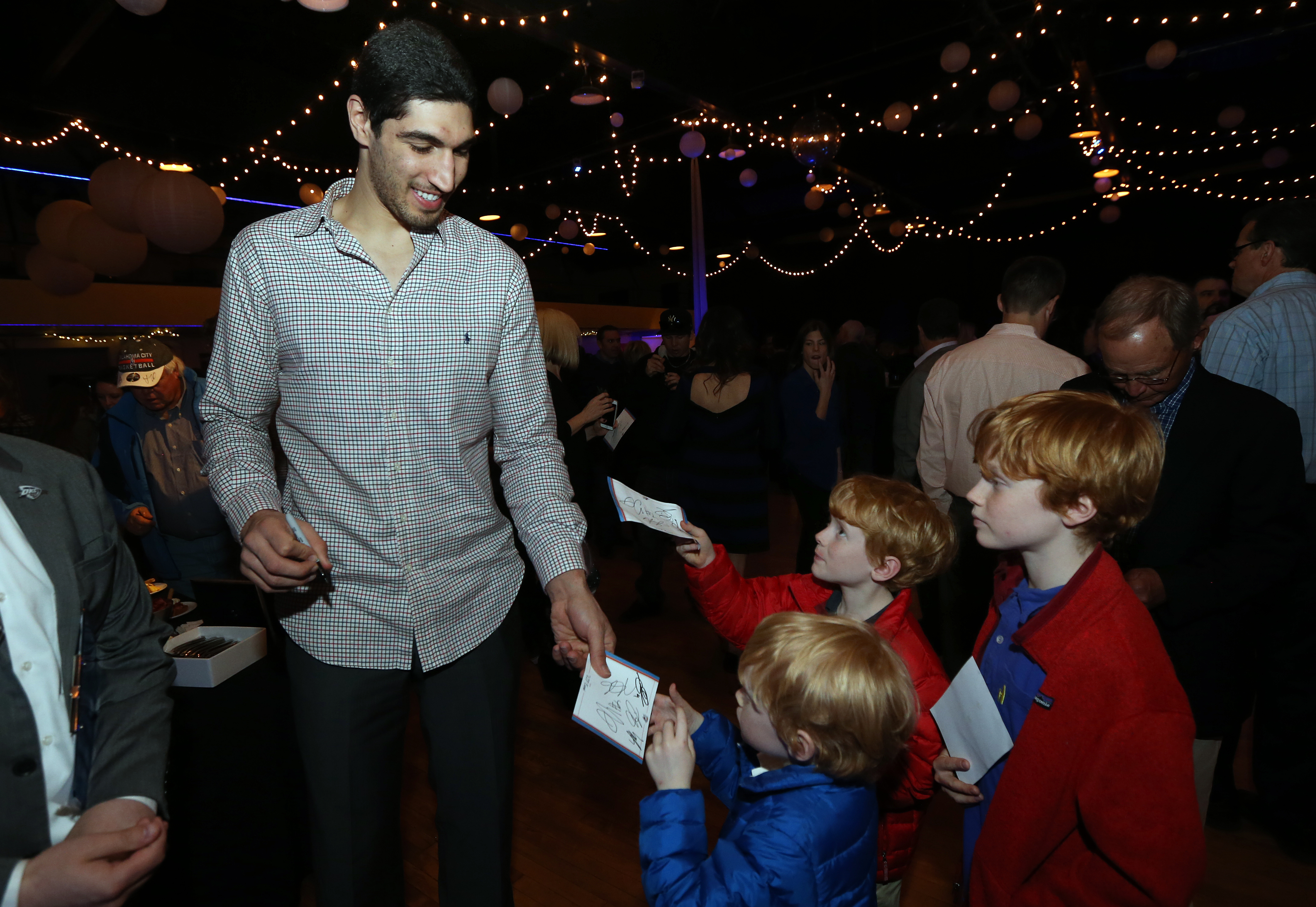 Enes Kanter #34 of the Oklahoma City Thunder signs autographs for fans at a Thunder Season ticket holder VIP event on March 3, 2015 at the Oklahoma City Farmers Market in Oklahoma City, Oklahoma. (Layne Murdoch—NBAE/Getty Images)