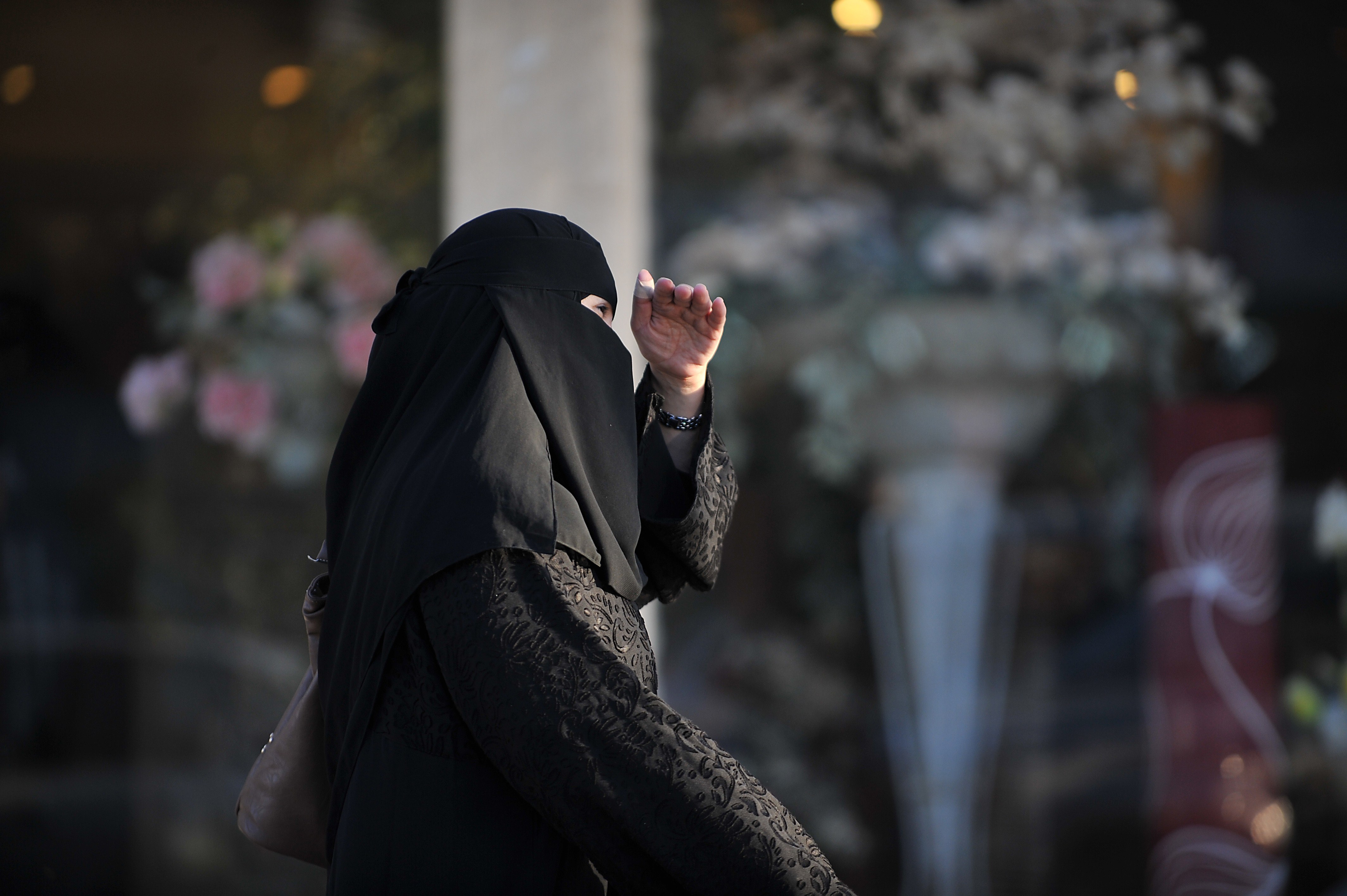 A Saudi woman walks past a flower shop in Riyadh, Saudi Arabia on February 13, 2014. (Fayez Nureldine—AFP/Getty Images)