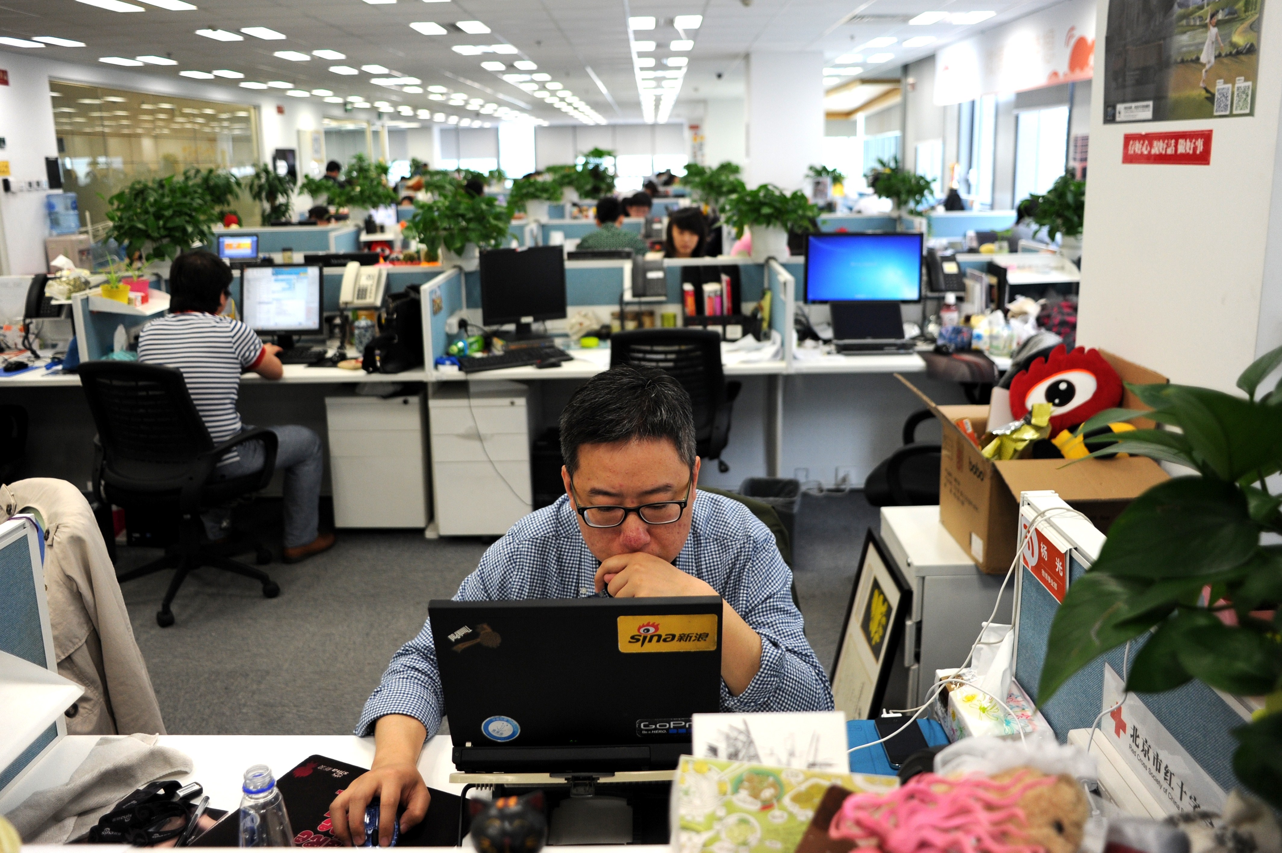 This picture taken on April 16, 2014 shows a man using a laptop at an office of Sina Weibo, widely known as China's version of Twitter, in Beijing. (Wang Zhao—AFP/Getty Images)