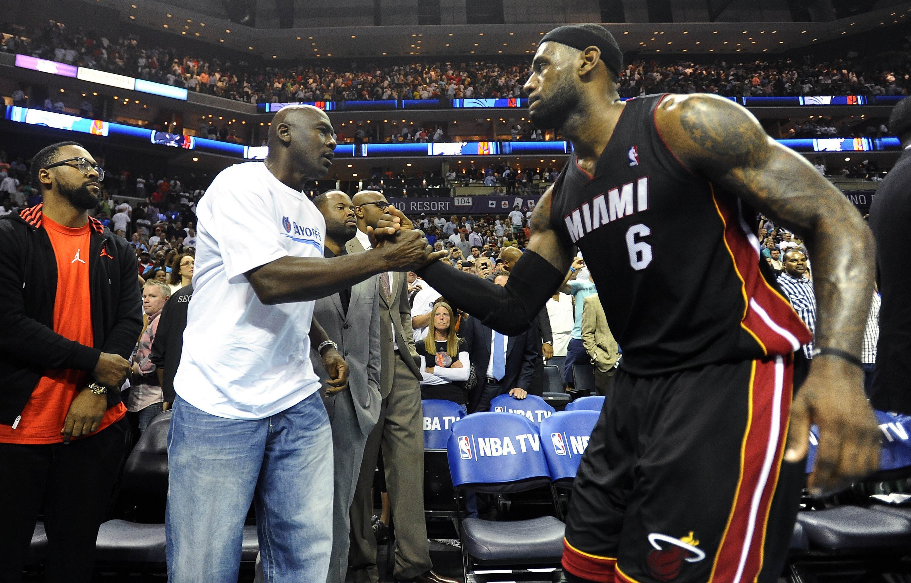 Charlotte Bobcats' team owner Michael Jordan shakes hands with Miami Heat forward LeBron James (6), after the Heat defeated the Bobcats, 109-98, in Game 4 of the NBA Eastern Conference quarterfinals at Time Warner Cable Arena in Charlotte, N.C., Monday, April 28, 2014. (Charlotte Observer—Getty Images)