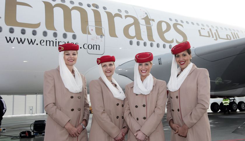 Emirates stewardesses pose in front of an aircraft. (Krafft Angerer&mdash;Getty Images)
