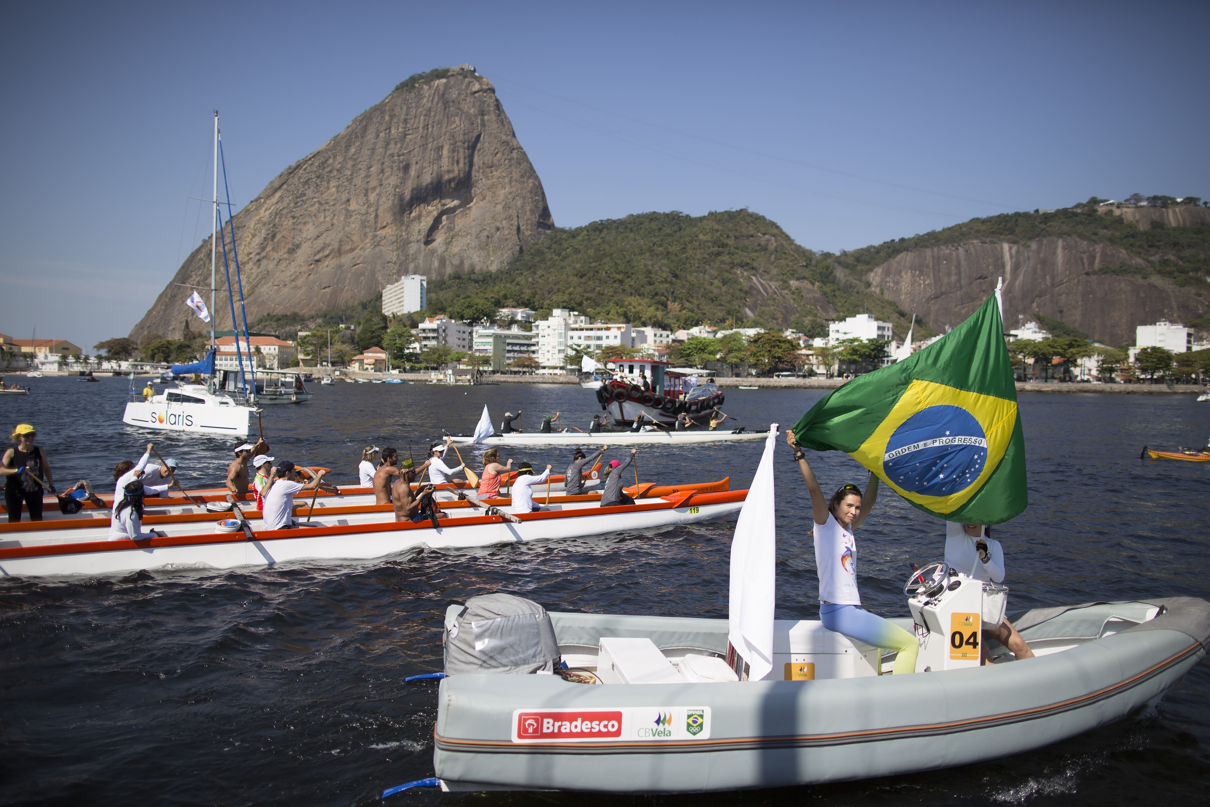 A woman flies Brazil's national flag on a boat during a protest in the Marina da Gloria in Rio de Janeiro on Aug. 8, 2015. (Leo Correa—AP)