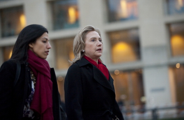 Hillary Clinton and Huma Abedin arrive for a NATO Foreign Minister family photo in front of the Brandenburg Gate in Berlin April 14, 2011. (SAUL LOEB—AFP/Getty Images)