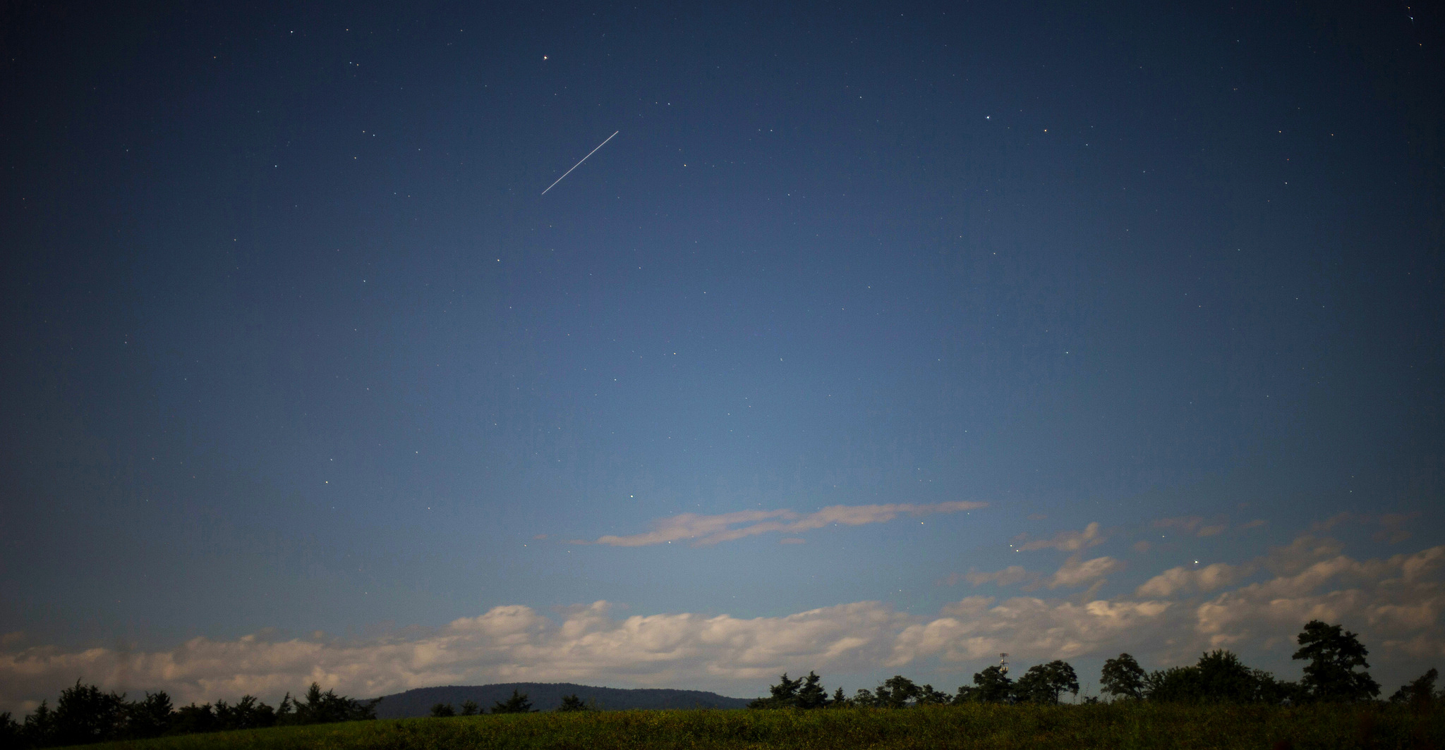 The International Space Station is seen in this 10 second exposure as it flies over Elkton, Va. early in the morning on Aug. 1, 2015.