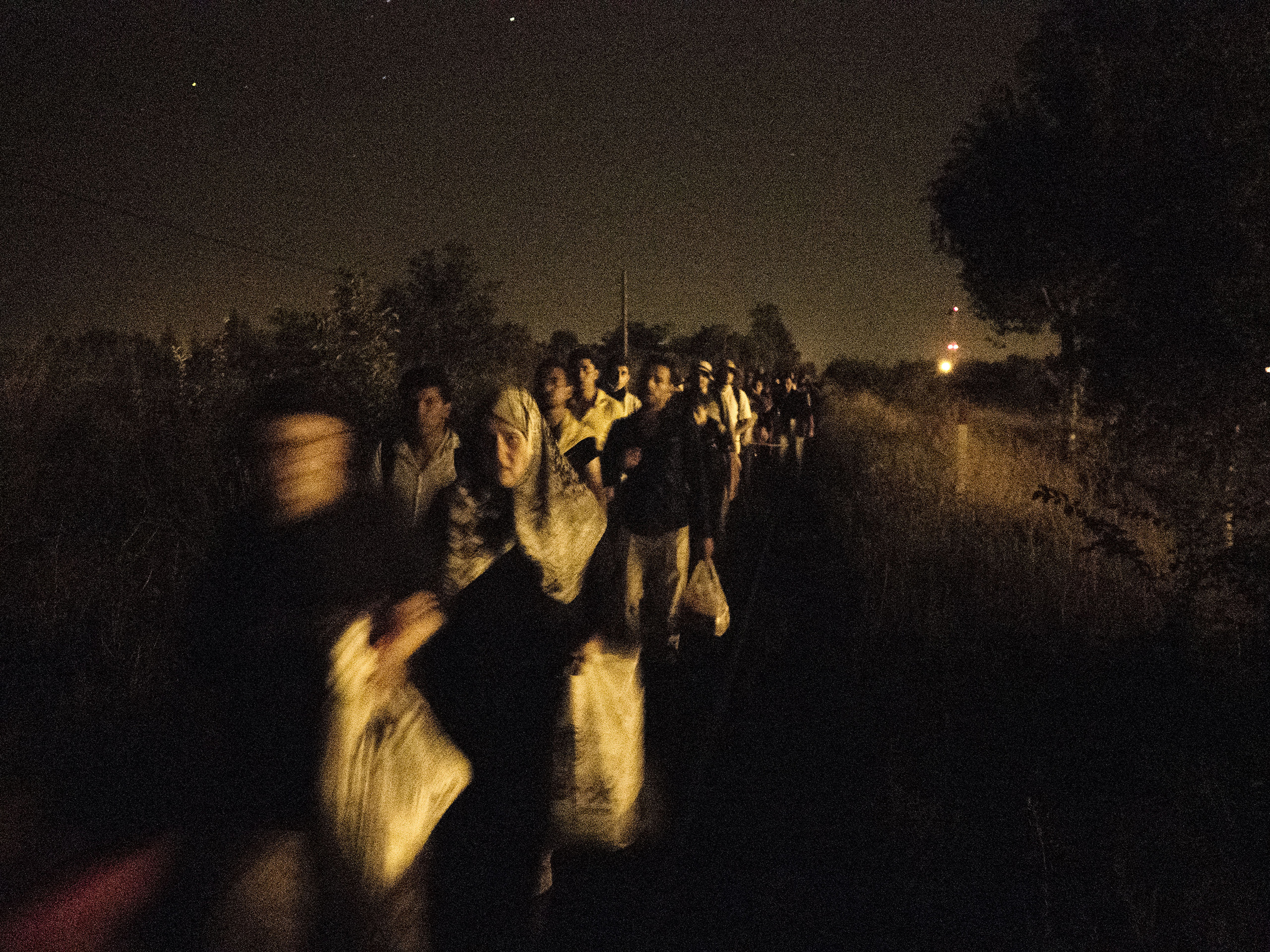 Horgos, Serbia. August 12, 2015. Syrian families walk at night toward the border to attempt to cross it.