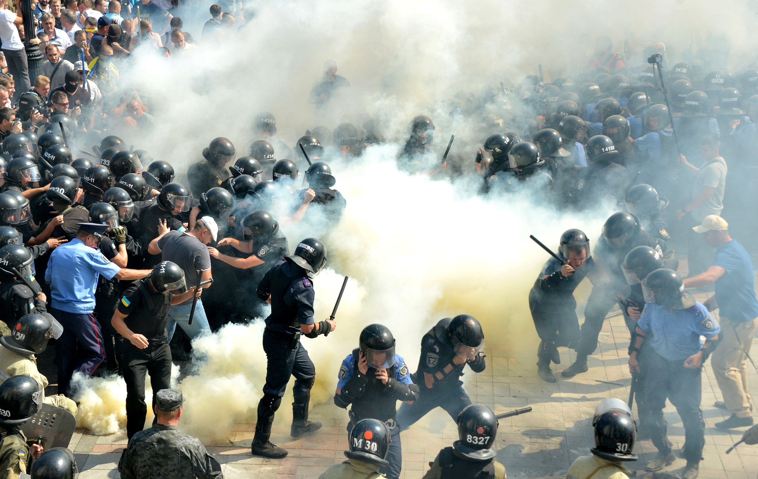 Smoke rises near the parliament building in Kiev, Ukraine, as activists of radical Ukrainian parties, including the Ukrainian nationalist party Svoboda (Freedom), clash with police officers on Aug. 31, 2015.