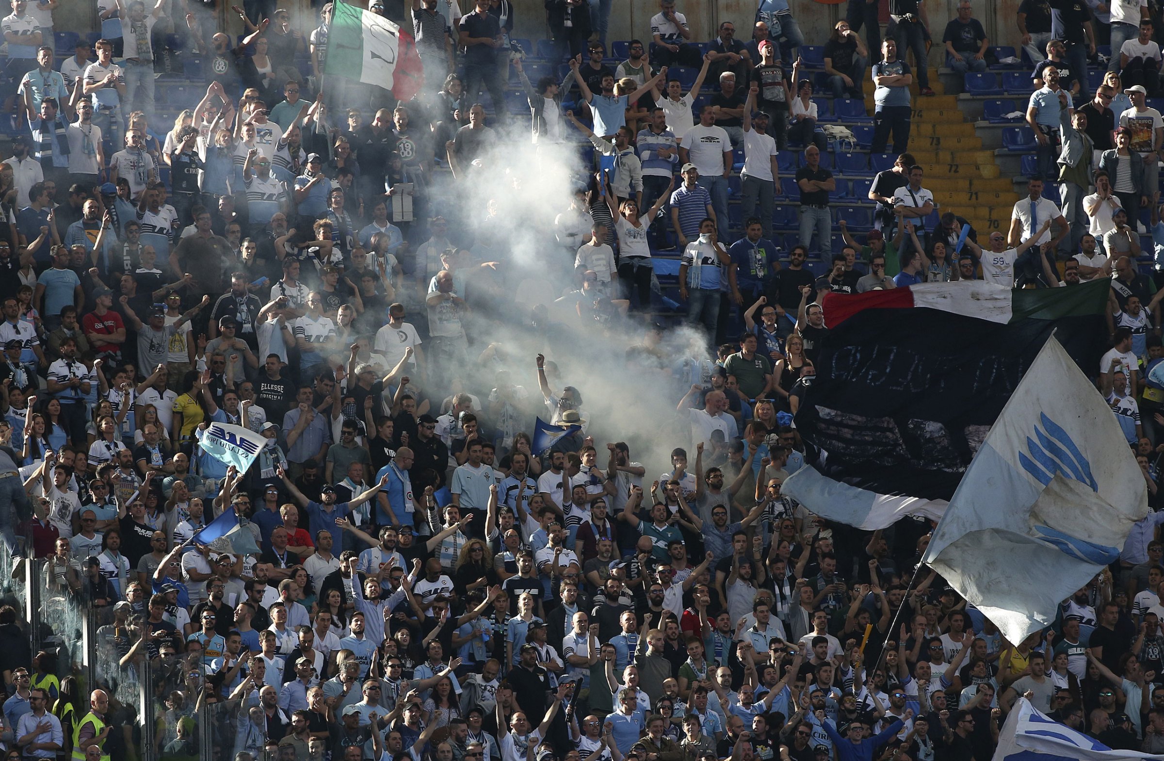 Lazio's supporters shout slogans before their Serie A soccer match against AS Roma at the Olympic stadium in Rome