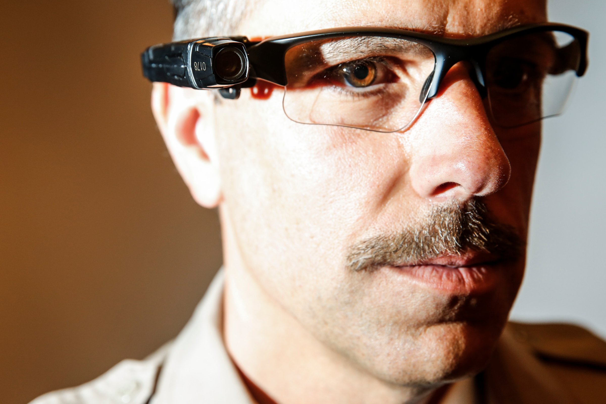 County of Los Angeles Sheriff's Lt. Chris Marks poses wearing the Taser Axon Flex, on-officer camera system attached to glasses in Monterey Park on Sept. 17, 2014.