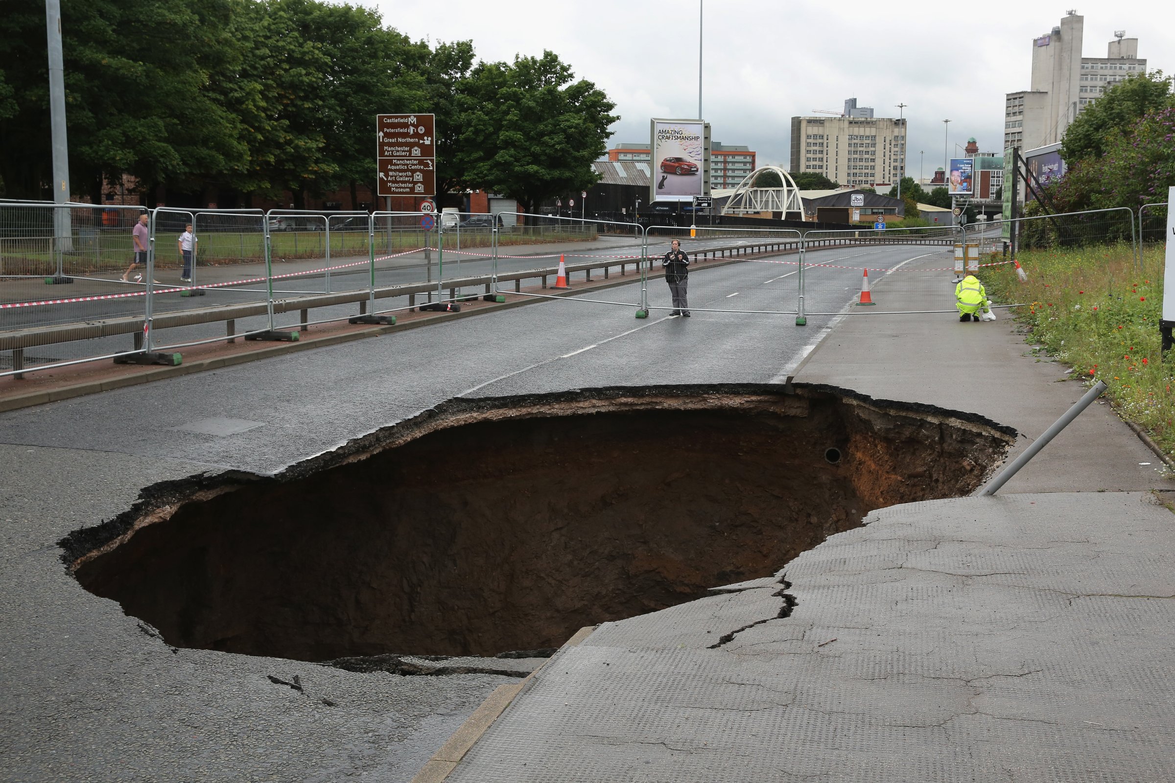 Manchester Sinkhole Appears as Heavy Rain Sweeps Britain