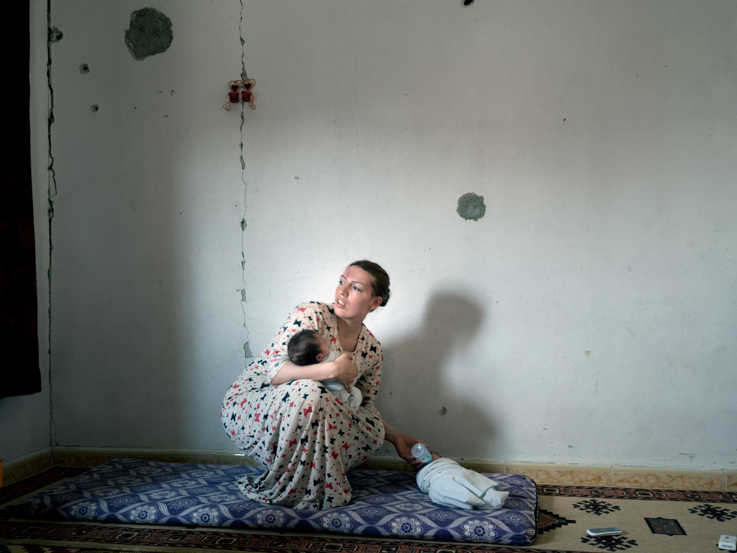 SYRIA. Kobani / Kobane (Arabic: Ayn al Arab) . 07 August 2015. Arin with her twin sons. She returned to Kobane four months ago.
