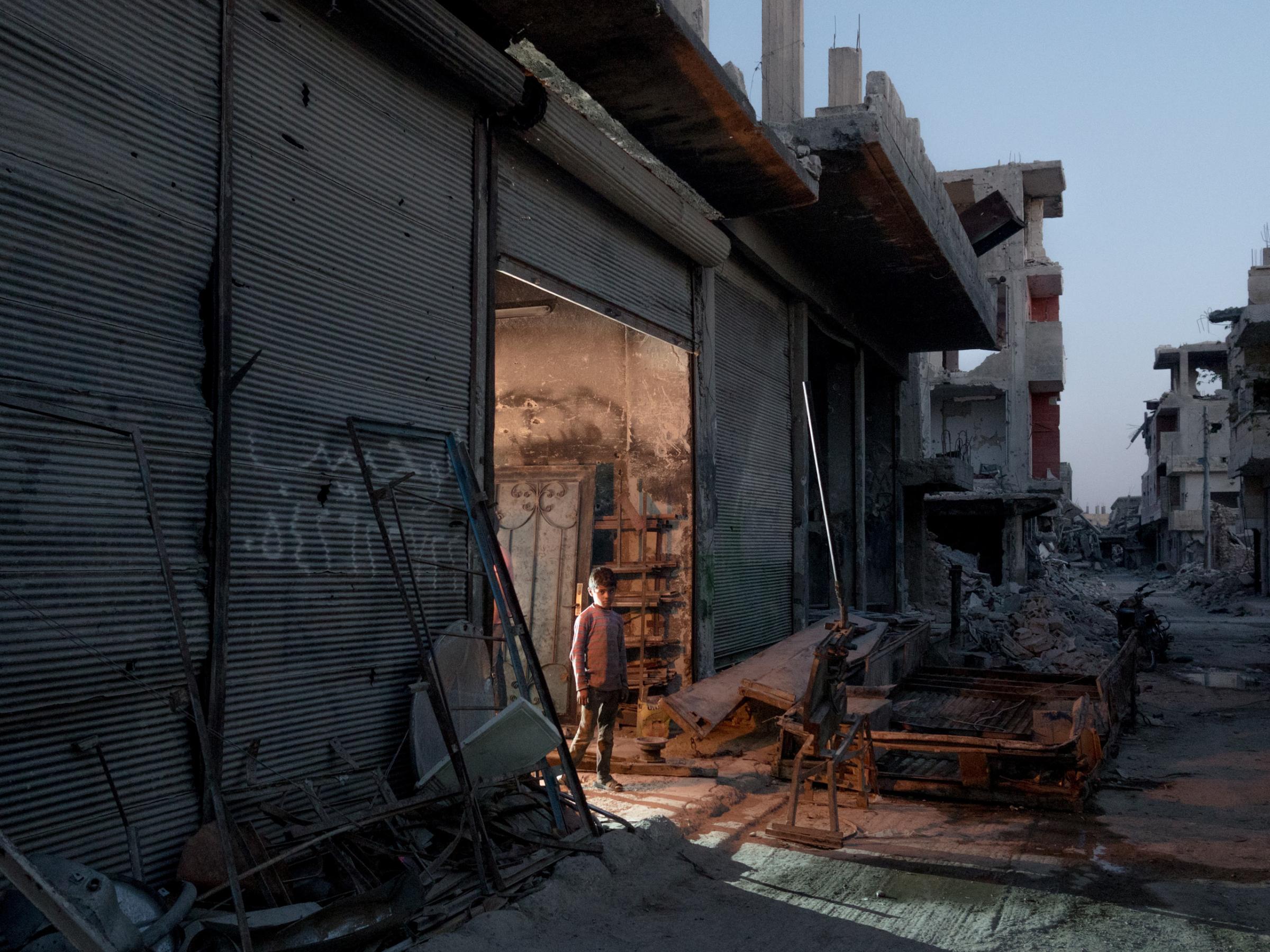 SYRIA. Kobani / Kobane (Arabic: Ayn al Arab) . 08 August 2015. A young boy working as a blacksmith