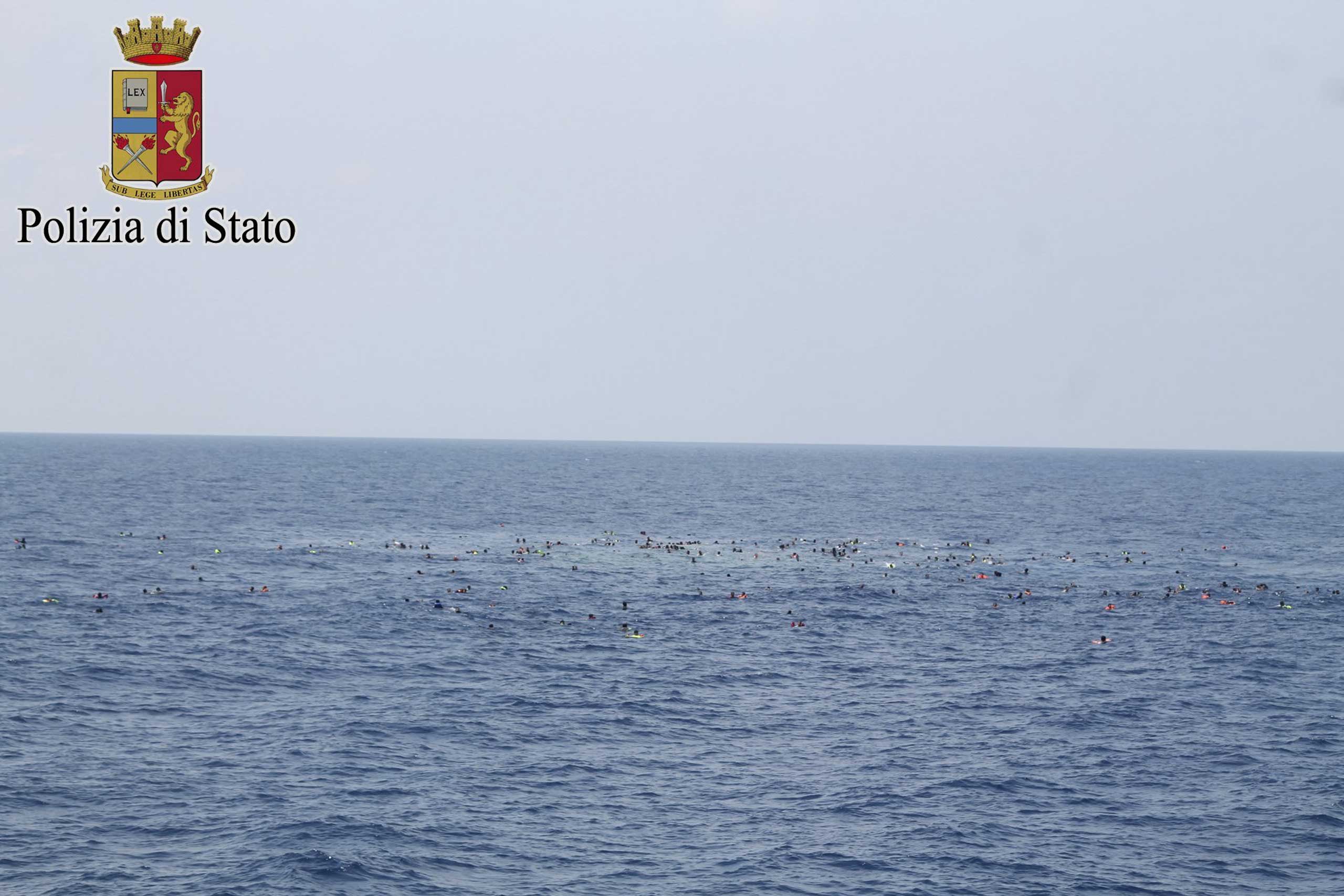 Surviving migrants are seen swimming in the area where their wooden boat capsized and sank off the coast of Libya on Aug. 5, 2015. (Italian Police/Reuters)