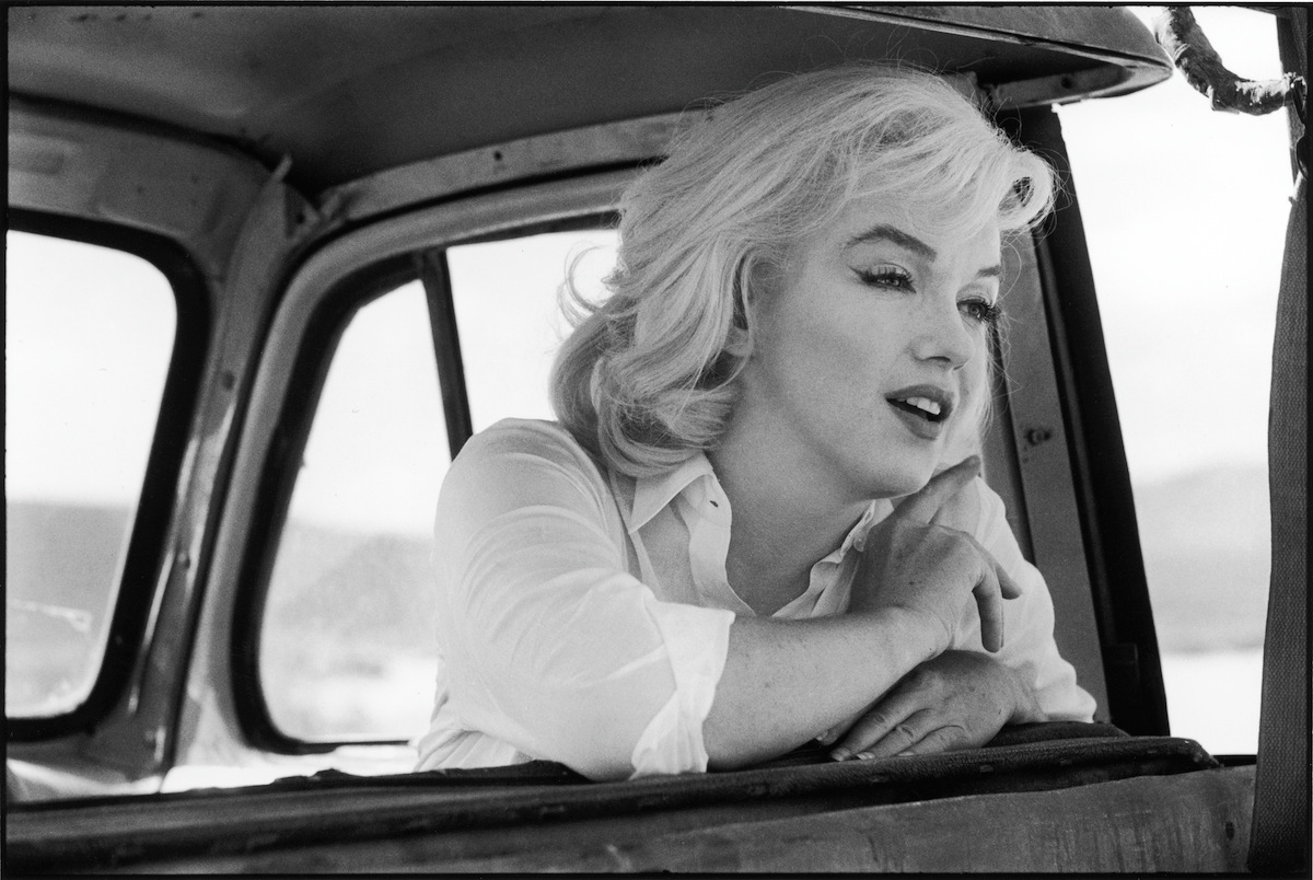 Marilyn Monroe  leans over the back of the front seat of a car on the set of 'The Misfits,' directed by John Huston, Nevada, 1960. (Ernst Haas—Getty Images)