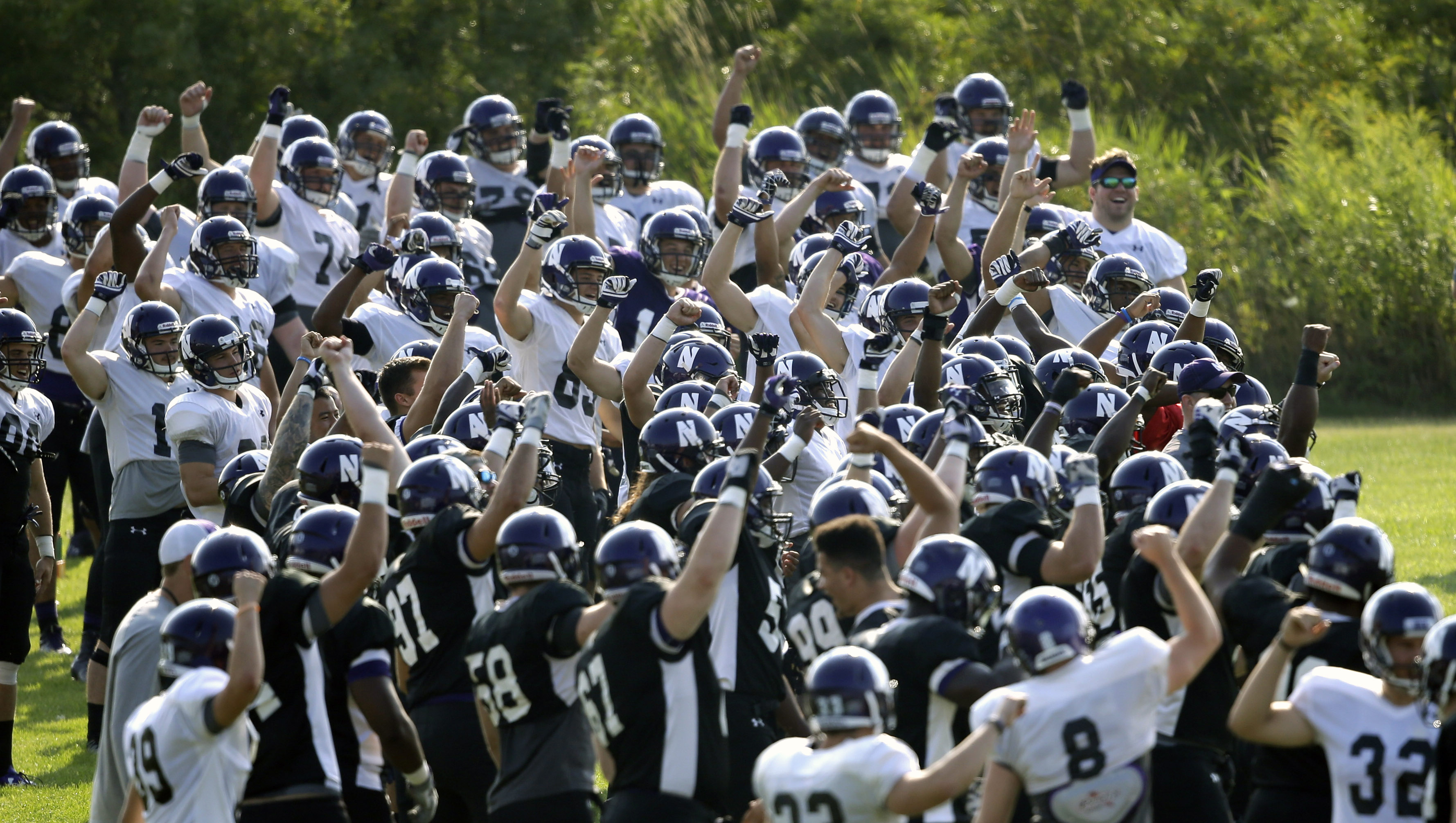 Northwestern football players gesture during practice at the University of Wisconsin-Parkside campus on Aug. 17, 2015, in Kenosha, Wi. (Jeffrey Phelps—AP)