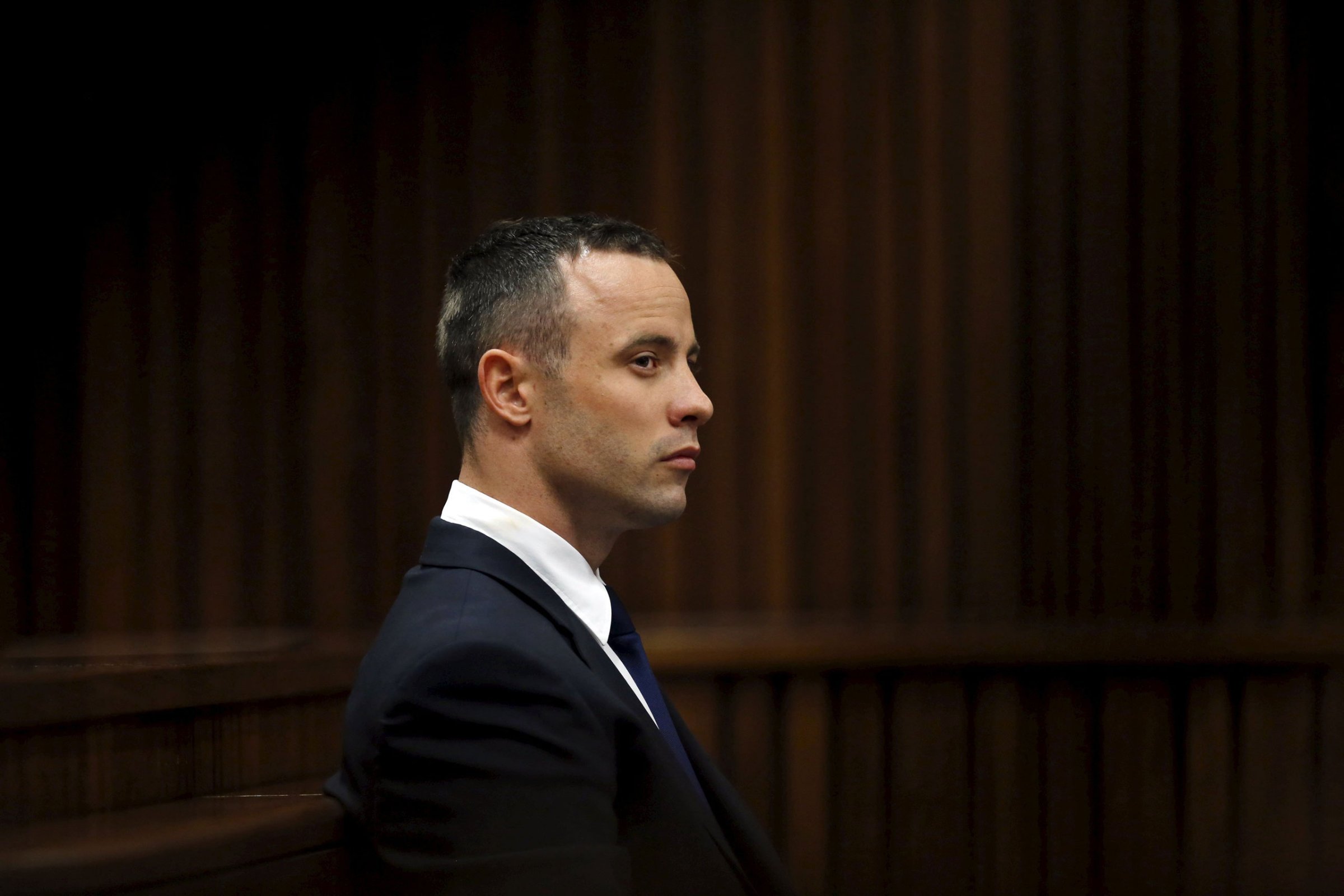 "Blade Runner" Oscar Pistorius sits in the dock during his trial in the North Gauteng High Court in Pretoria, in this file picture taken May 6, 2014. Pistorius, 29, is expected to wear an electronic tracking tag when he is released on Friday after serving 10 months of a five-year sentence for killing his model and law graduate girlfriend Reeva Steenkamp on Valentine's Day 2013. REUTERS/Mike Hutchings/Files
