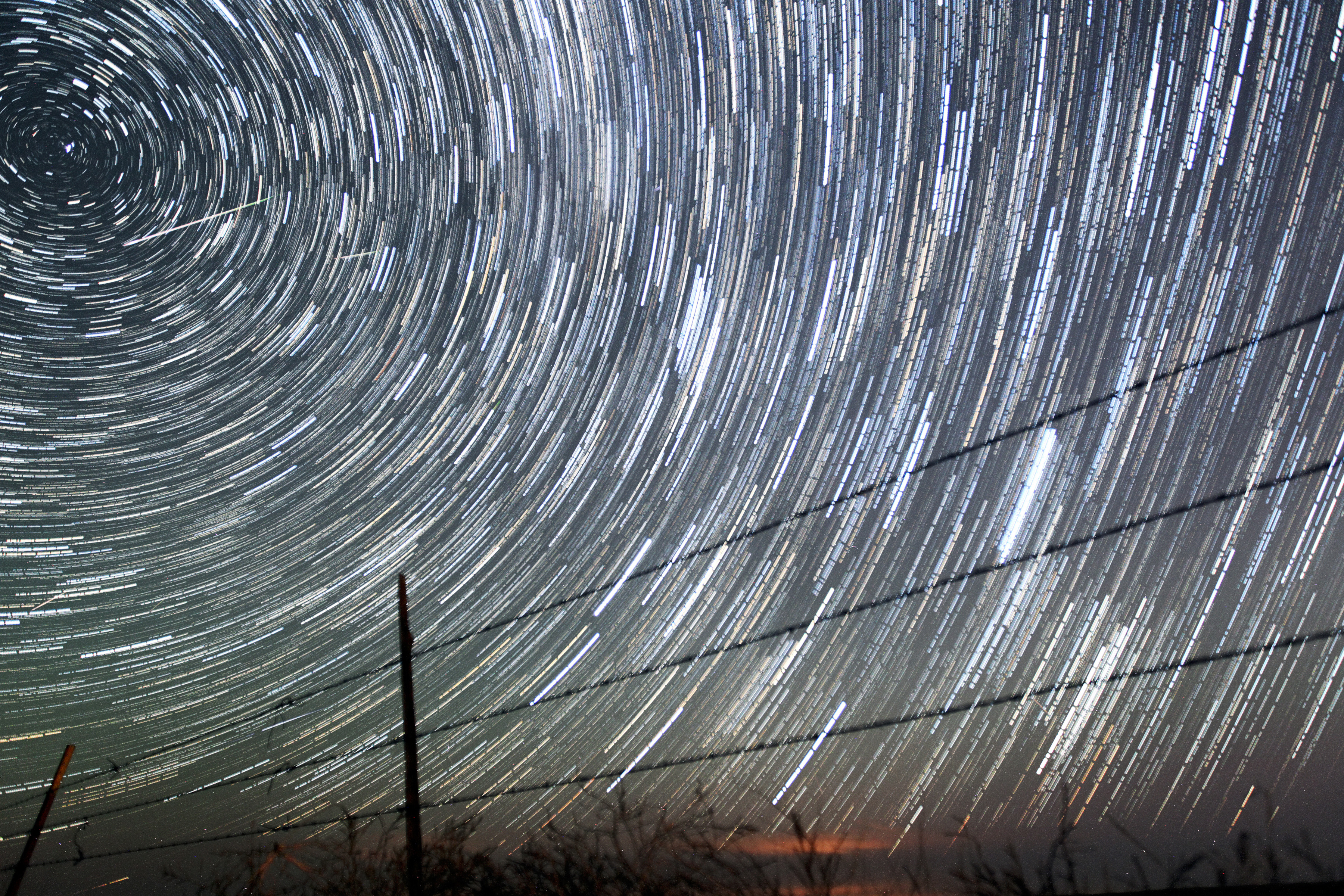 Perseid meteors, upper left, streak past time-lapse-captured stars early morning on Aug. 13, 2013 north of Cheyenne , Wyo. (Blaline McCartney—AP)