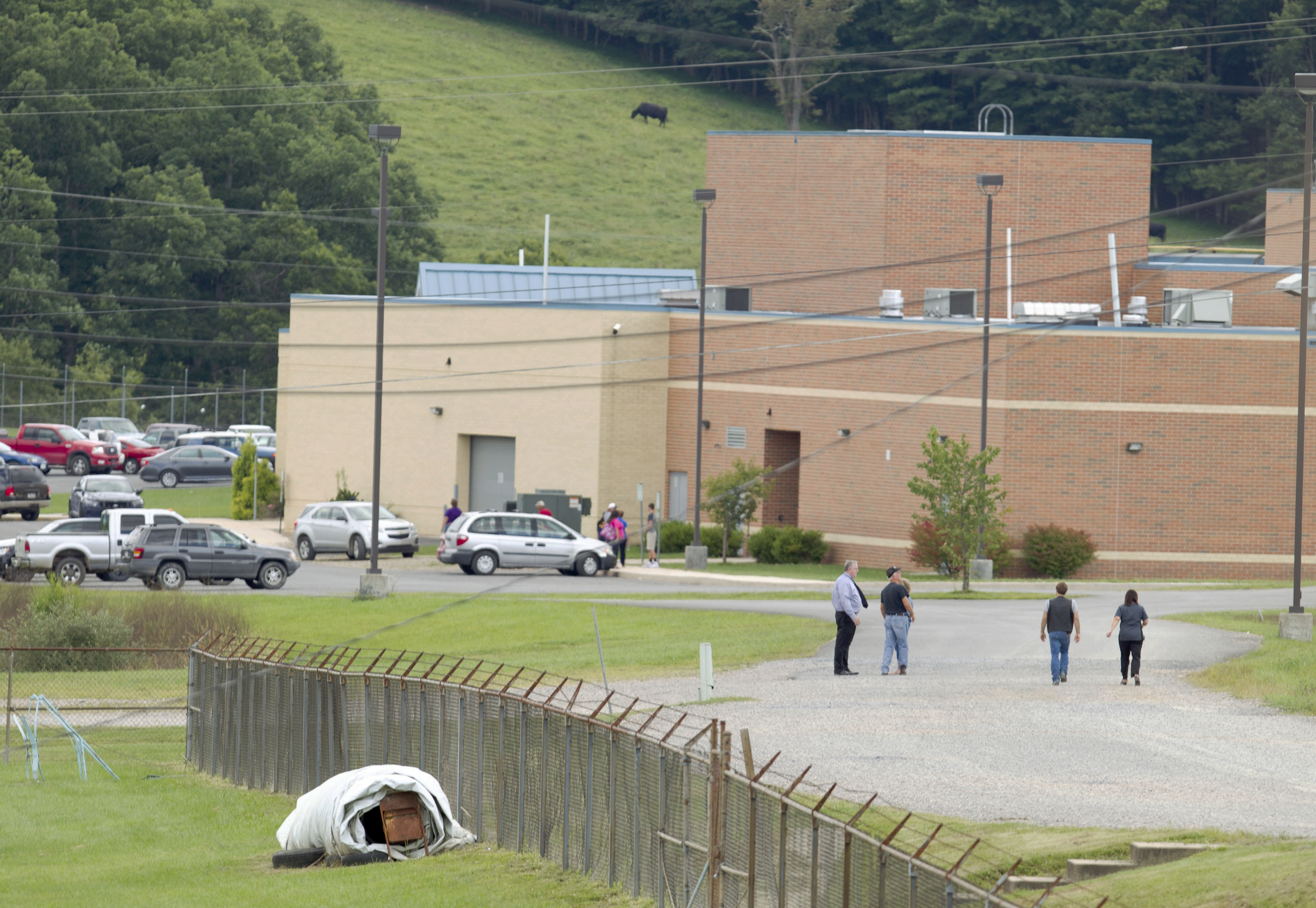 Parents of children from Philip Barbour High School in Philippi, W.Va., walk to the school to meet up with their children that were evacuated after a "hostage-like" situation occurred in the school on Aug. 25, 2015. (Ben Queen&mdash;AP)