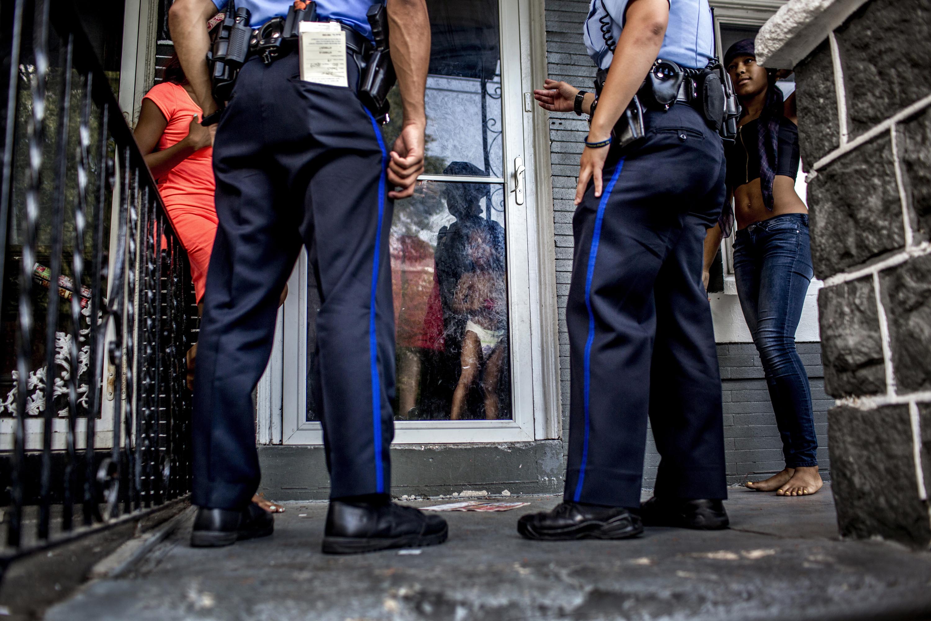 Police officers respond to a young woman who said she was threatened by an ex-boyfriend on July 28 in Philadelphia’s 19th District (Natalie Keyssar for TIME)