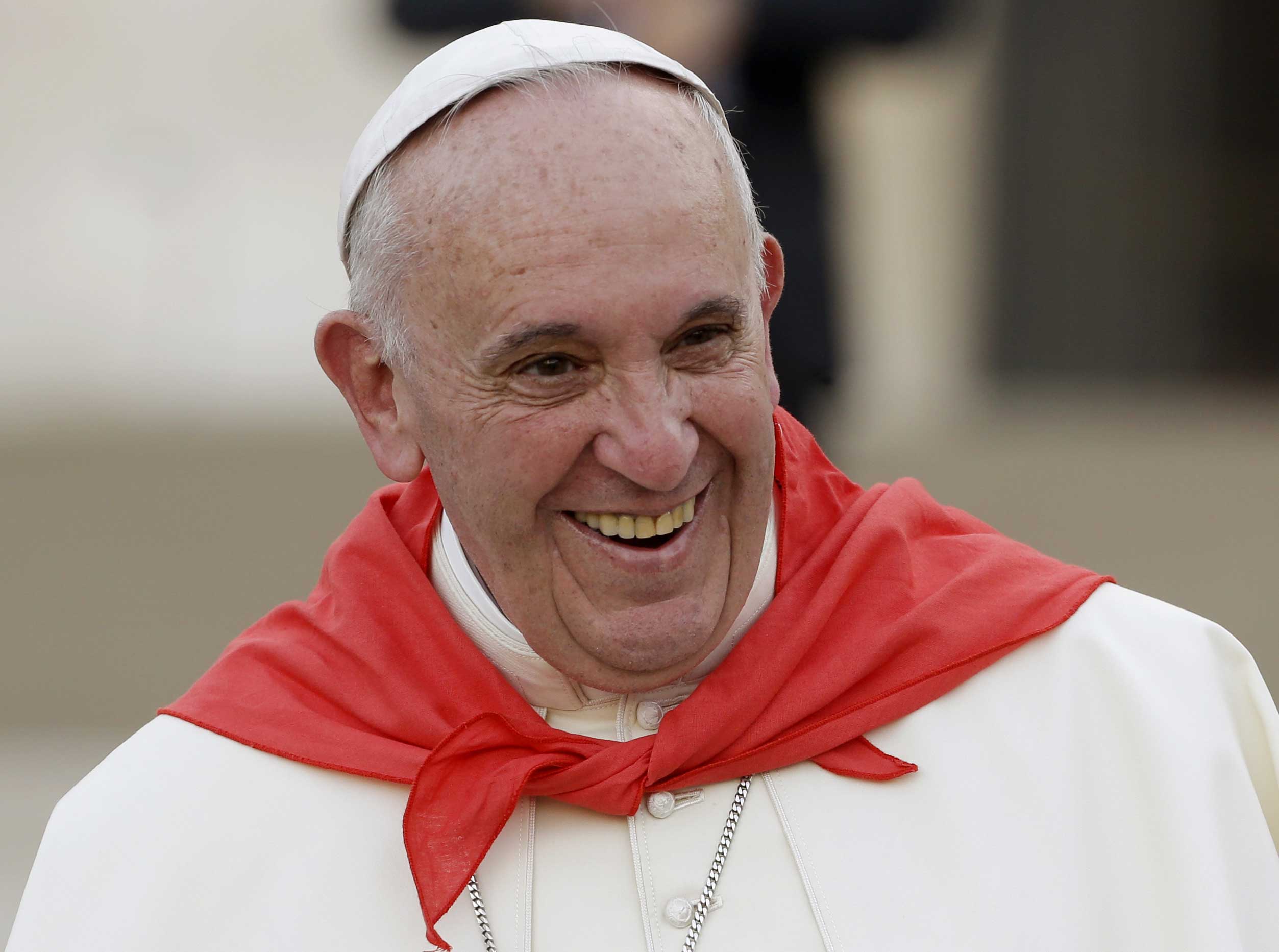 Pope Francis, wearing a red scarf, has a light moment as he leaves St. Peter's Square at the Vatican after an audience with with Altar boys and girls, Aug. 4, 2015. (Gregorio Borgia—AP)