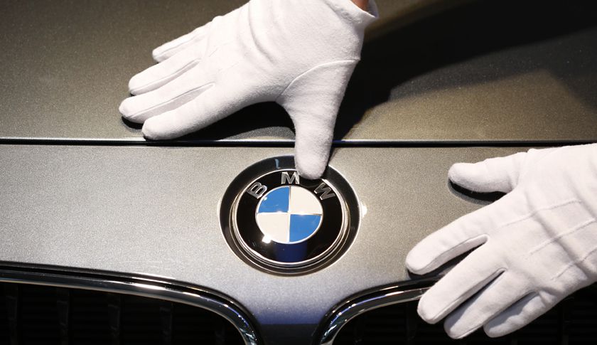 Man cleans BMW logo before news conference of German premium automaker BMW in Munich