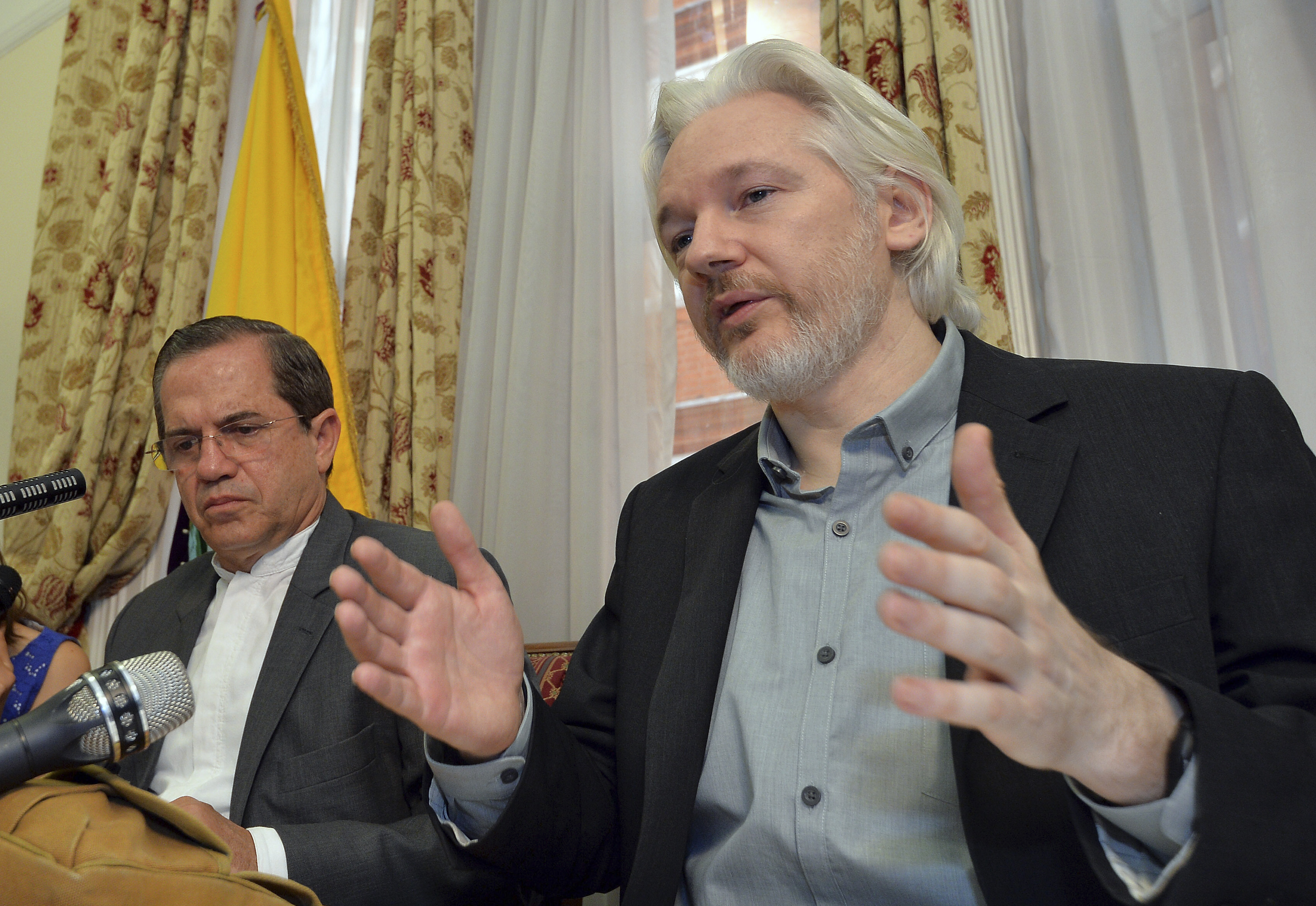WikiLeaks founder Julian Assange (R) speaks as Ecuador's Foreign Affairs Minister Ricardo Patino listens, during a news conference at the Ecuadorian embassy in central London August 18, 2014 (John Stillwell—Reuters)