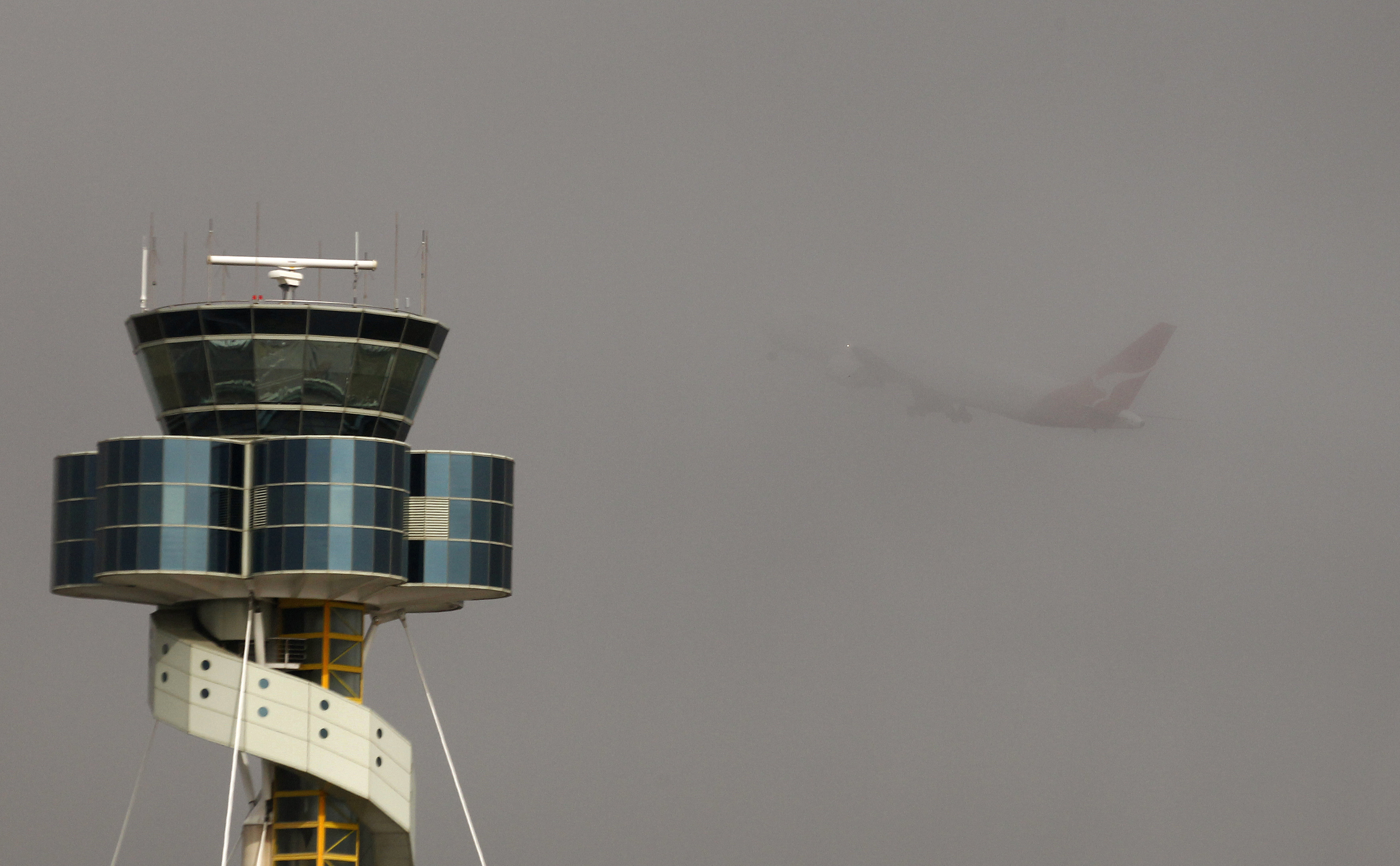 A Qantas plane takes off from Sydney airport amidst thick fog on May 29, 2013. (Daniel Munozz—Reuters)
