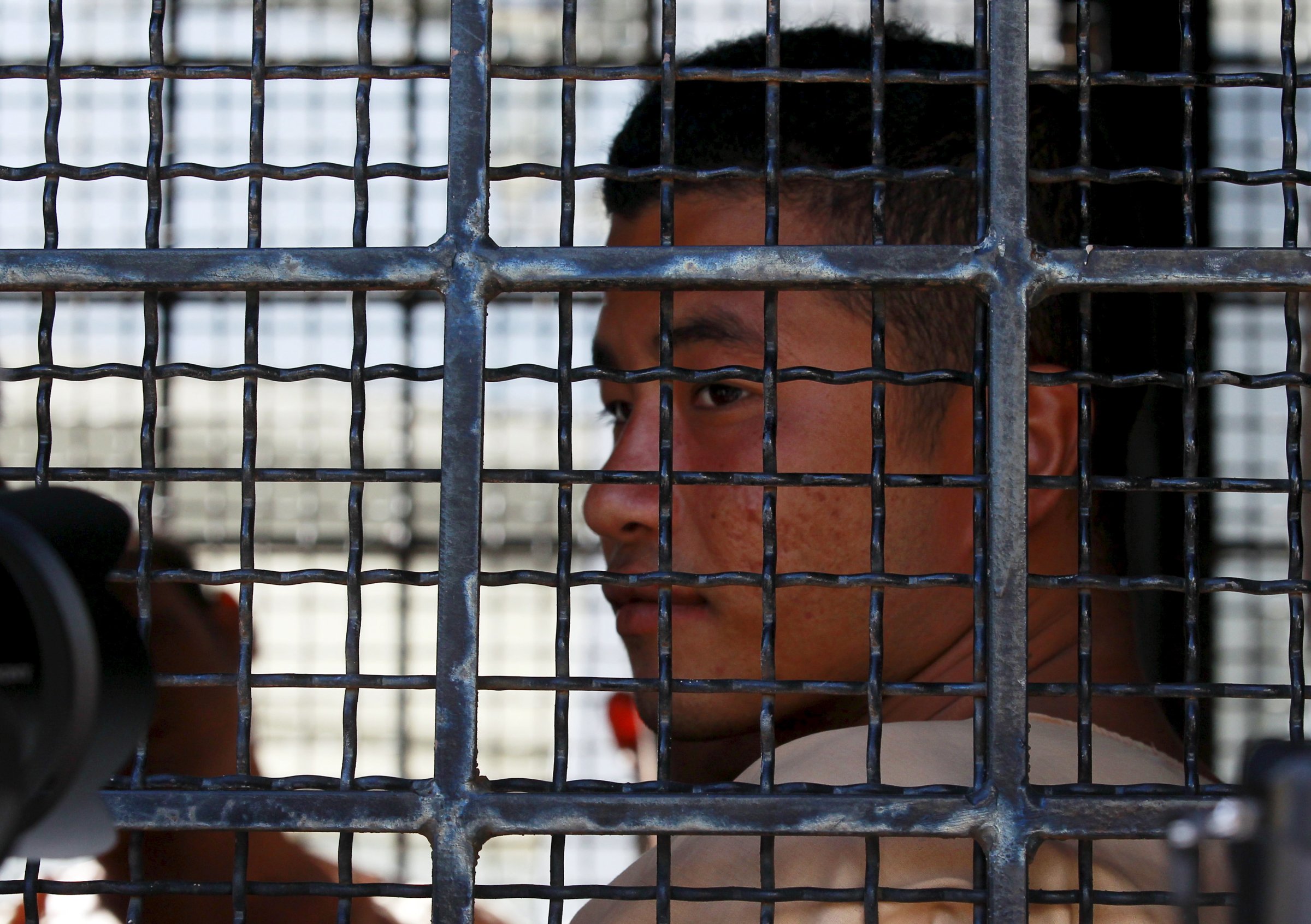 Myanmar migrant worker Win Zaw Htun sits in a prison truck as he arrives at the Koh Samui Provincial Court, in Koh Samui