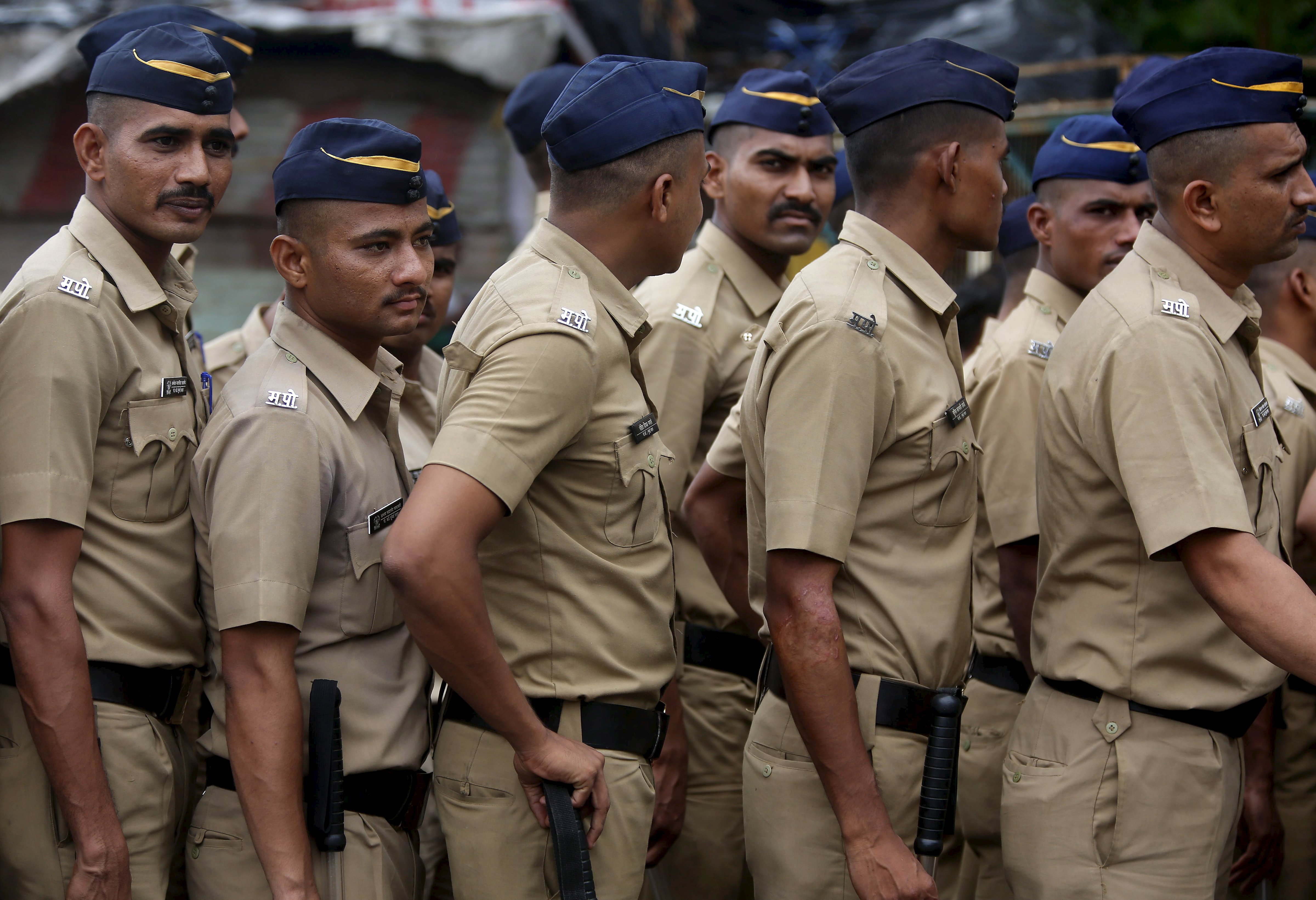 Indian policemen stand guard near the residence of Memon in Mumbai