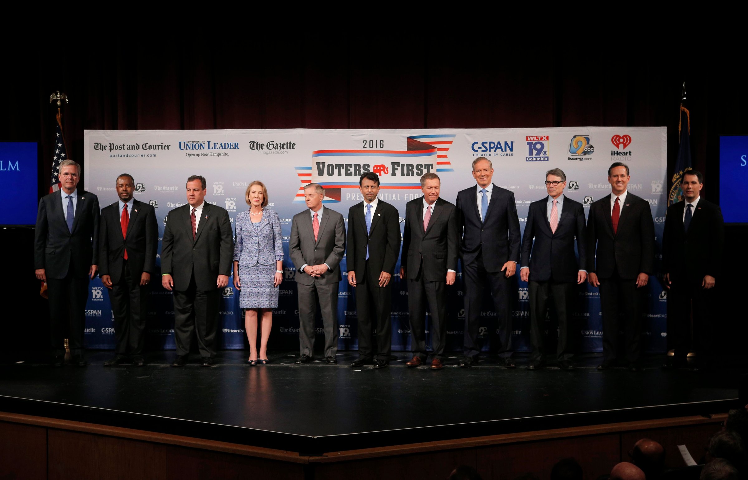 Eleven of the declared 2016 Republican U.S. presidential candidates pose together on stage before the start of the the Voters First Presidential Forum in Manchester