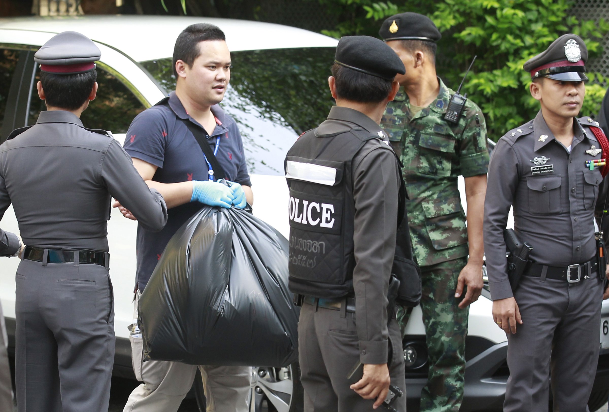 Thai Royal Police officials remove evidence from the site where a suspect of the recent Bangkok blast was arrested, in Bangkok