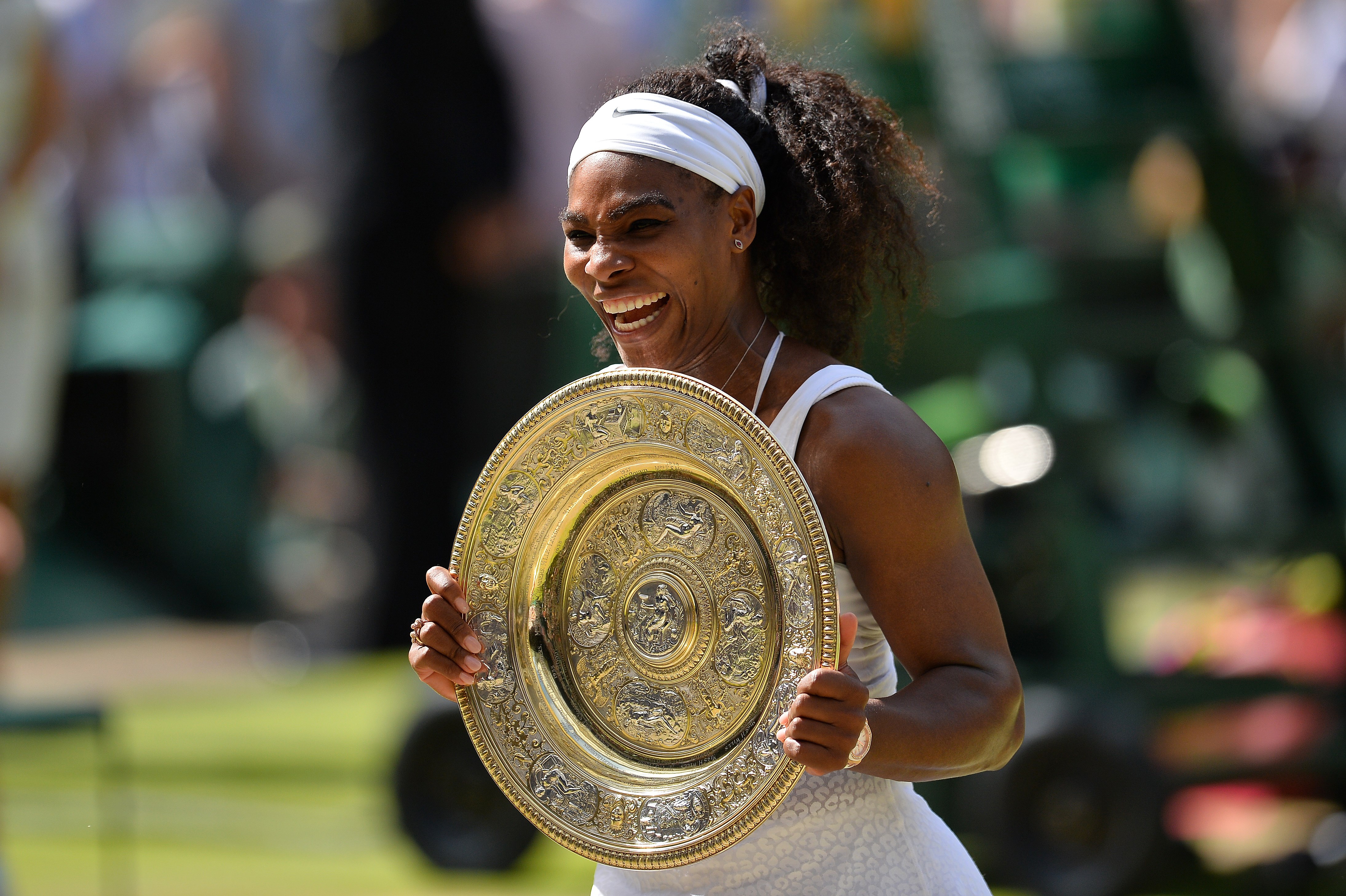 Serena Williams celebrates with the winner's trophy after her women's singles final victory over Spain's Garbine Muguruza at the 2015 Wimbledon Championships in London, on July 11, 2015. (Glyn Kirk—AFP/Getty Images)