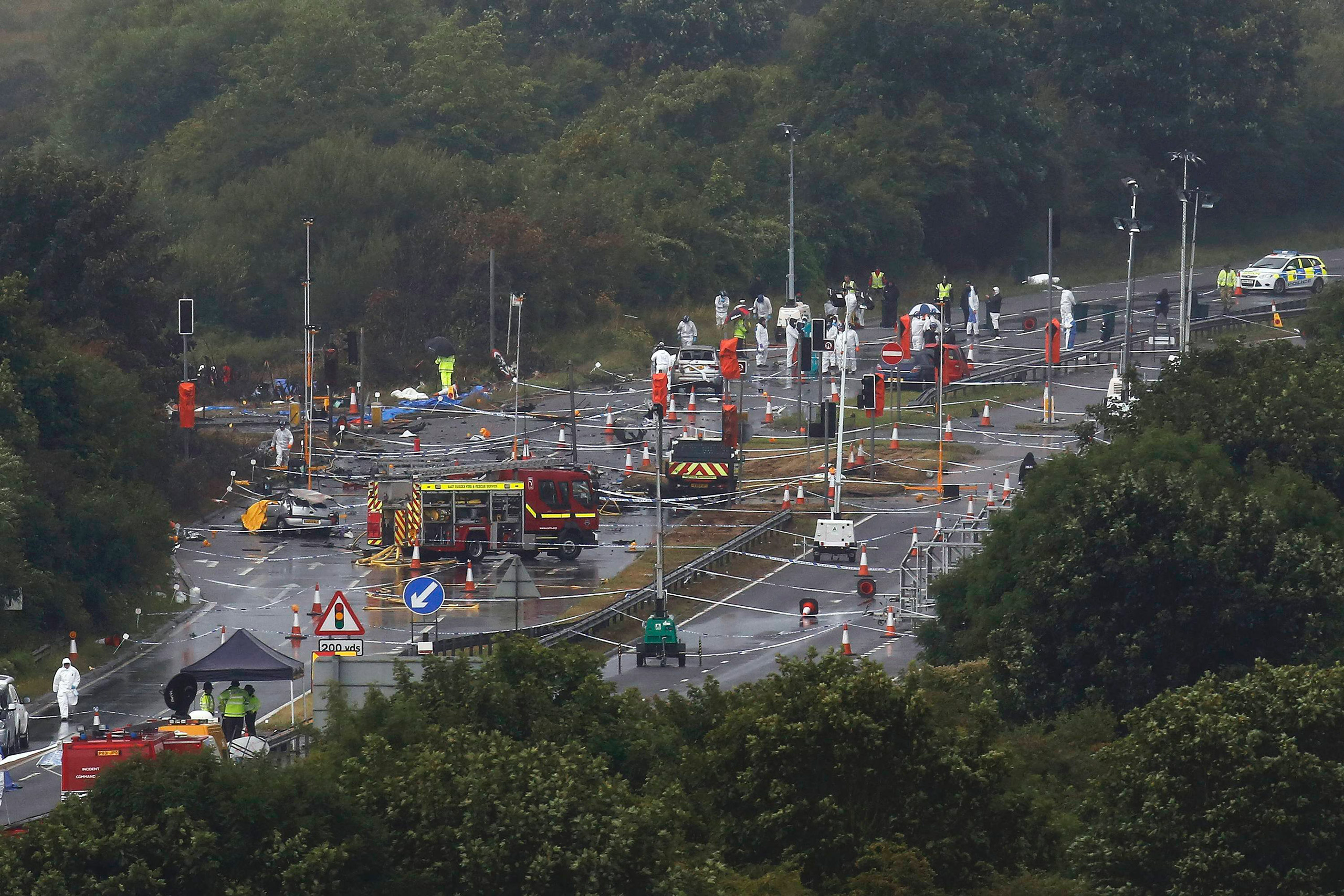 Emergency services and crash investigation officers continue to work at the site where a Hawker Hunter fighter jet crashed onto the A27 road at Shoreham near Brighton, U.K., Aug. 24, 2015. (Luke MacGregor—Reuters)
