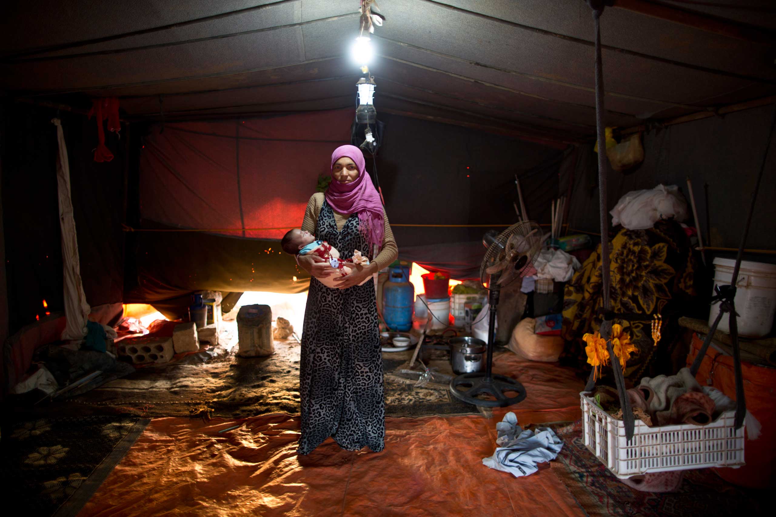 Wazeera Elaiwi, 29, holds her 2-month-old son Mohammed, on Aug. 11, 2015.