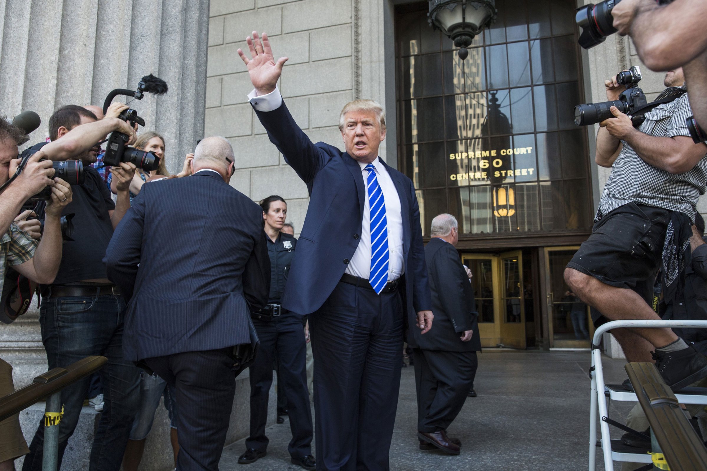 NEW YORK, NY - AUGUST 17: Republican Presidential hopeful Donald Trump waves as he arrives at U.S. Federal Court to report for jury duty on August 17, 2015 in New York City. Trump spent the last few days on the campaign trail at the Iowa state fair before returning to New York to perform the civic duty. (Photo by Andrew Burton/Getty Images)