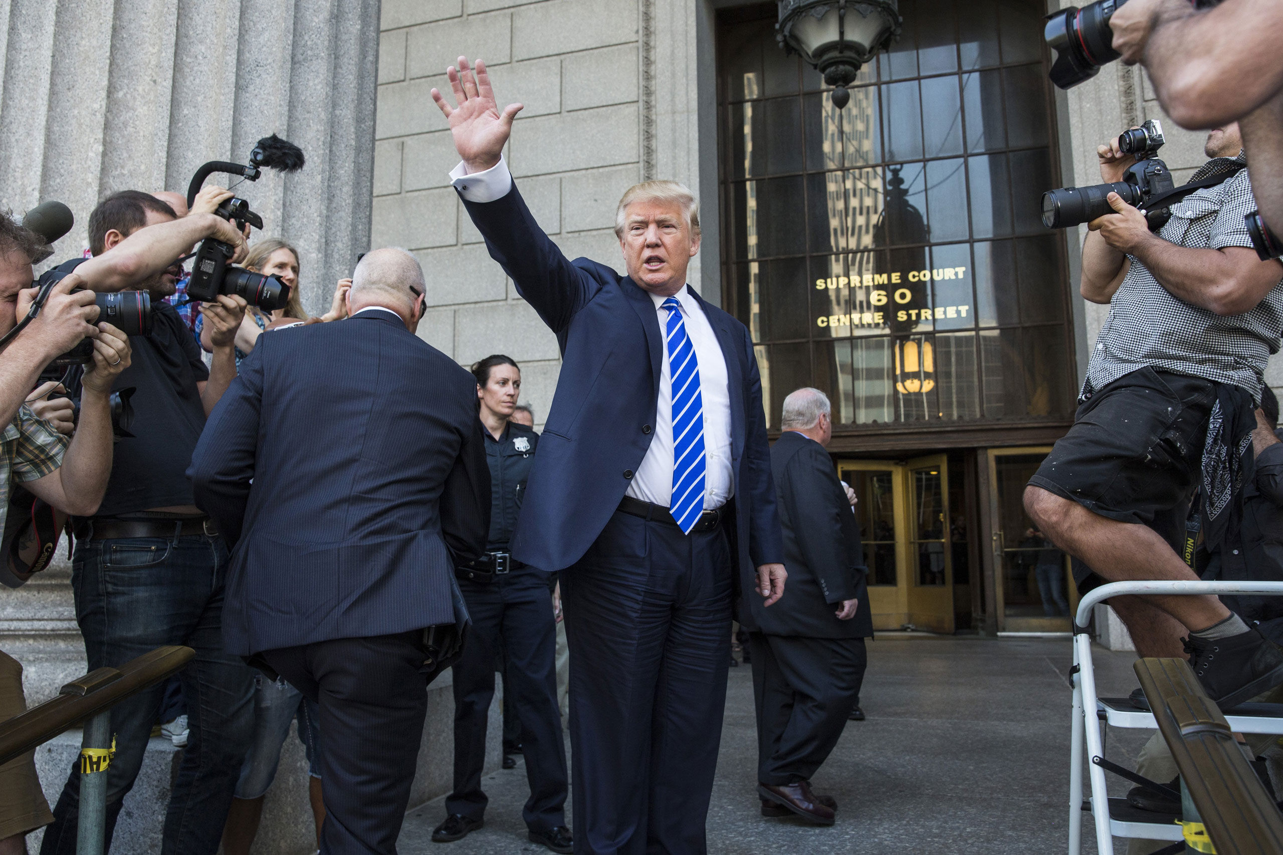 Donald Trump waves as he arrives at U.S. Federal Court to report for jury duty in New York City on August 17, 2015. (Andrew Burton—Getty Images)