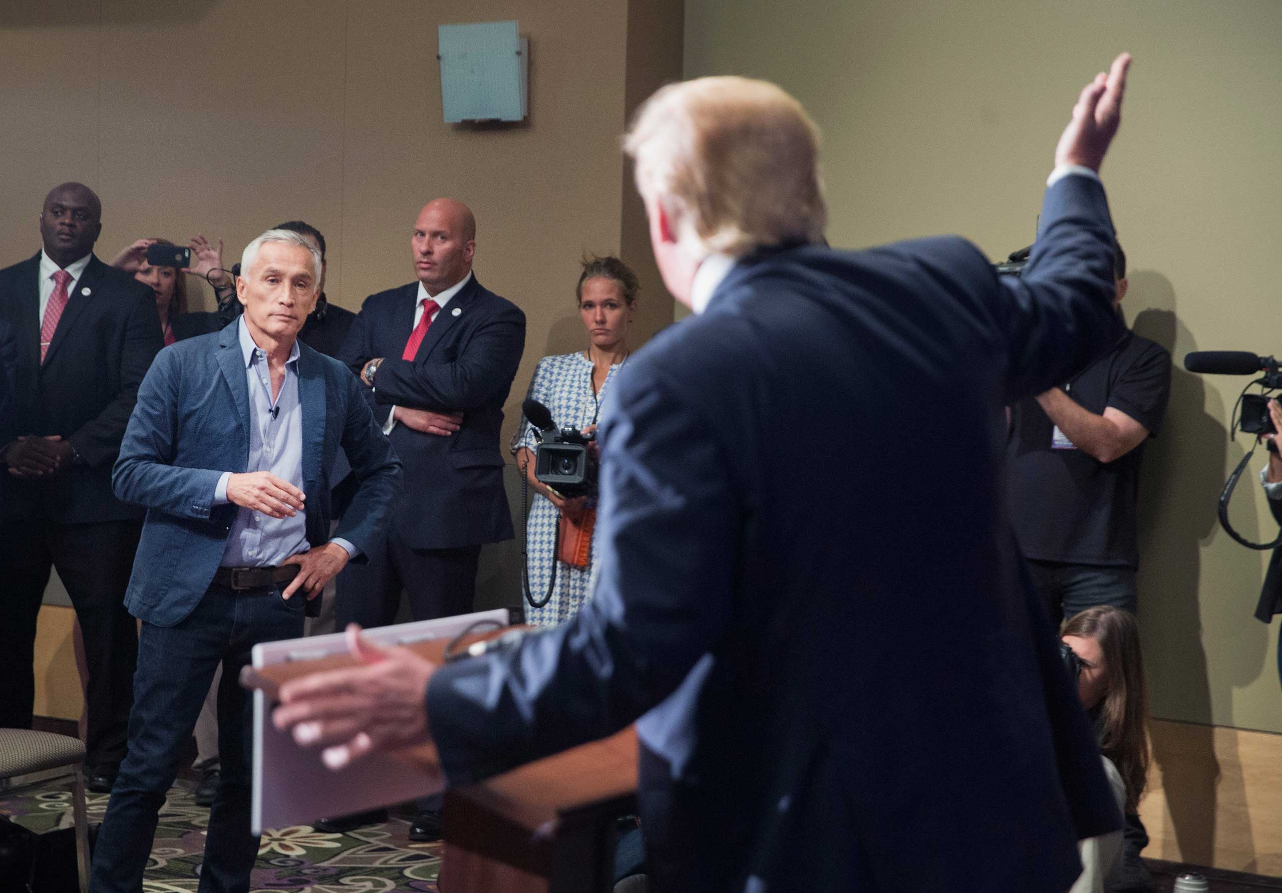 Republican presidential candidate Donald Trump fields a question from Univision and Fusion anchor Jorge Ramos during a press conference held before his campaign event at the Grand River Center in Dubuque, Iowa, on Aug. 25, 2015. (Scott Olson—Getty Images)