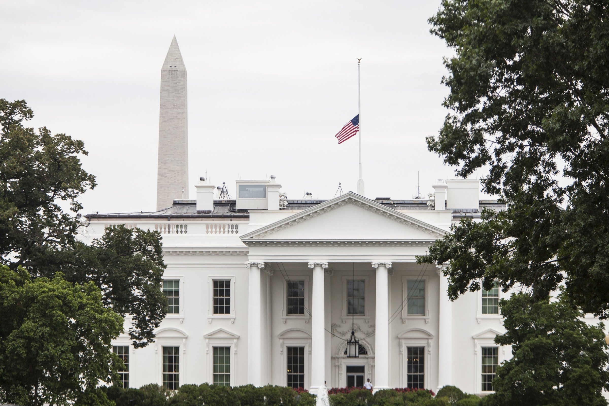 WASHINGTON, USA - JULY 21: The American Flag flies above the White House after President Barack Obama ordered it lowered to half staff in honor of the four Marines and one Sailor killed in Chattanooga, TN in Washington, USA on JULY 21, 2015. (Photo by Samuel Corum/Anadolu Agency/Getty Images)