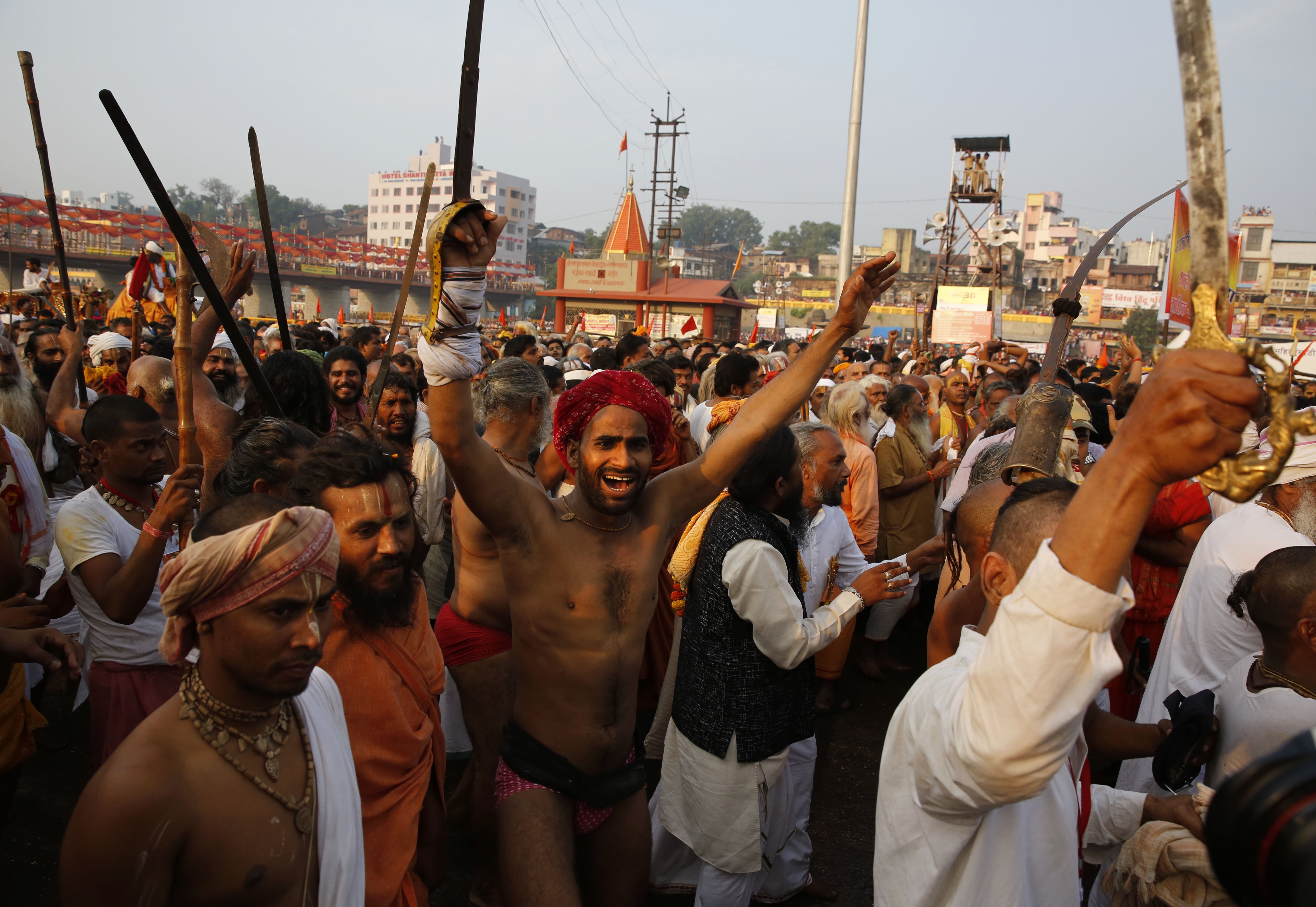 Indian Hindu holy men shout slogans as they arrive for holy dip on the second  shahi snan  or royal bath in the river Godavari during the ongoing Kumbh Mela in Nasik, India, on Sept. 13, 2015.
