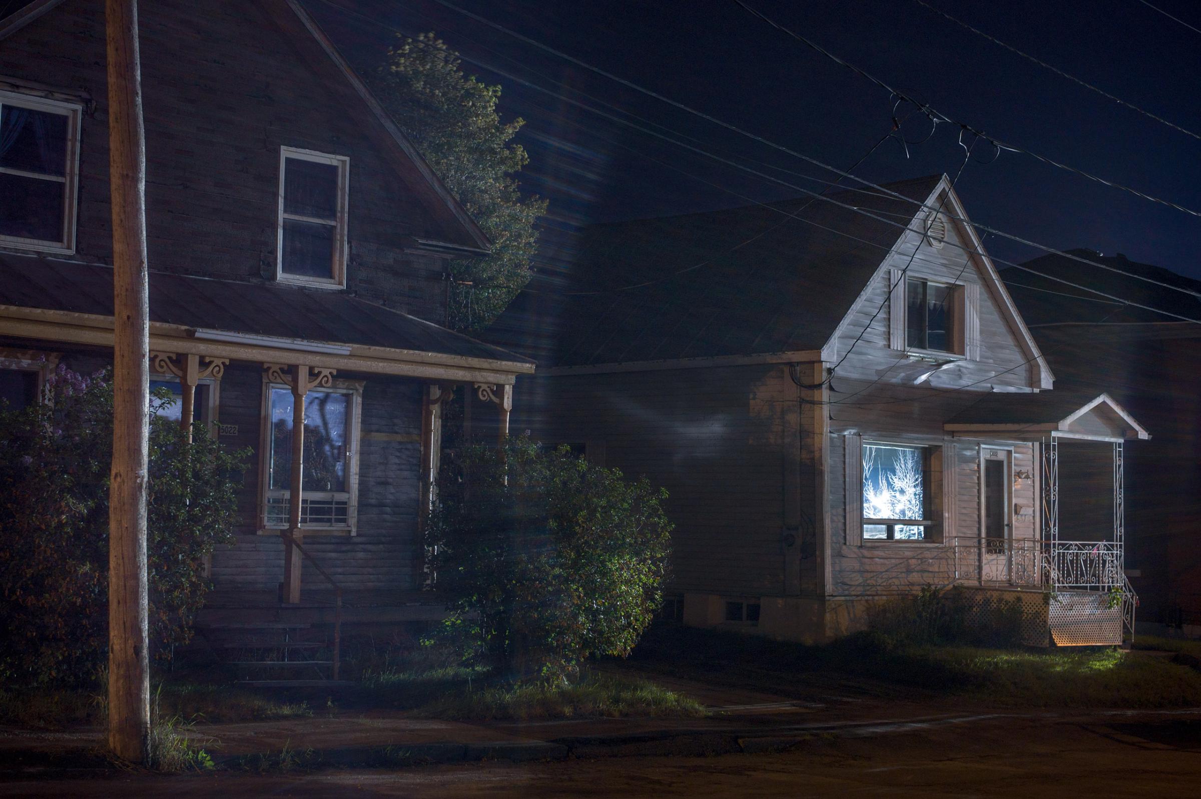 Houses lit by spotlights from the Red Zone, August 2013. From "Post MÈgantic" by Michel Huneault, winner of the 2015 Lange-Taylor Prize.