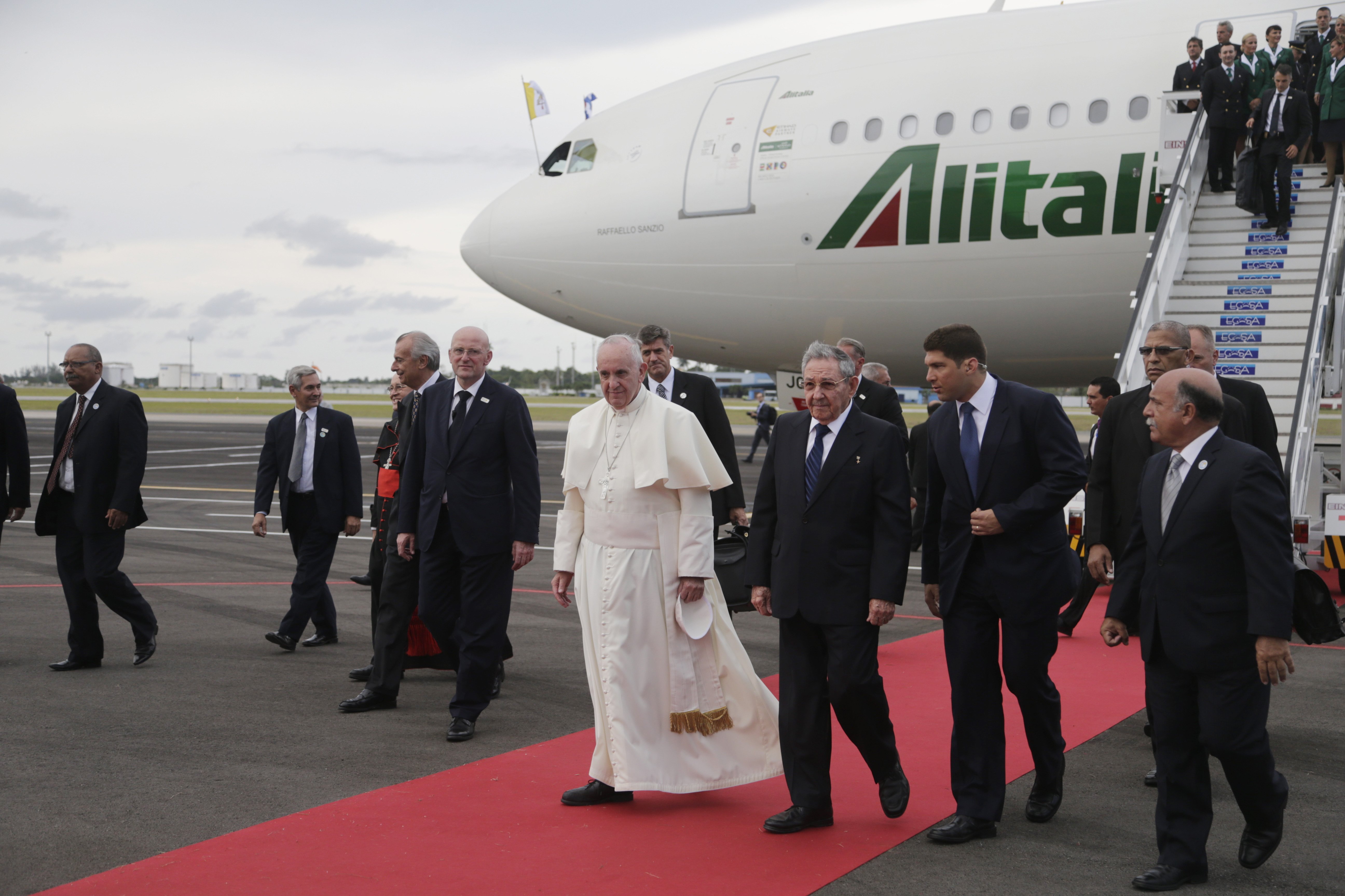 Cuba's President Raul Castro escorts Pope Francis during the pope's arrival ceremony at the airport in Havana, Cuba, on Sept. 19, 2015.