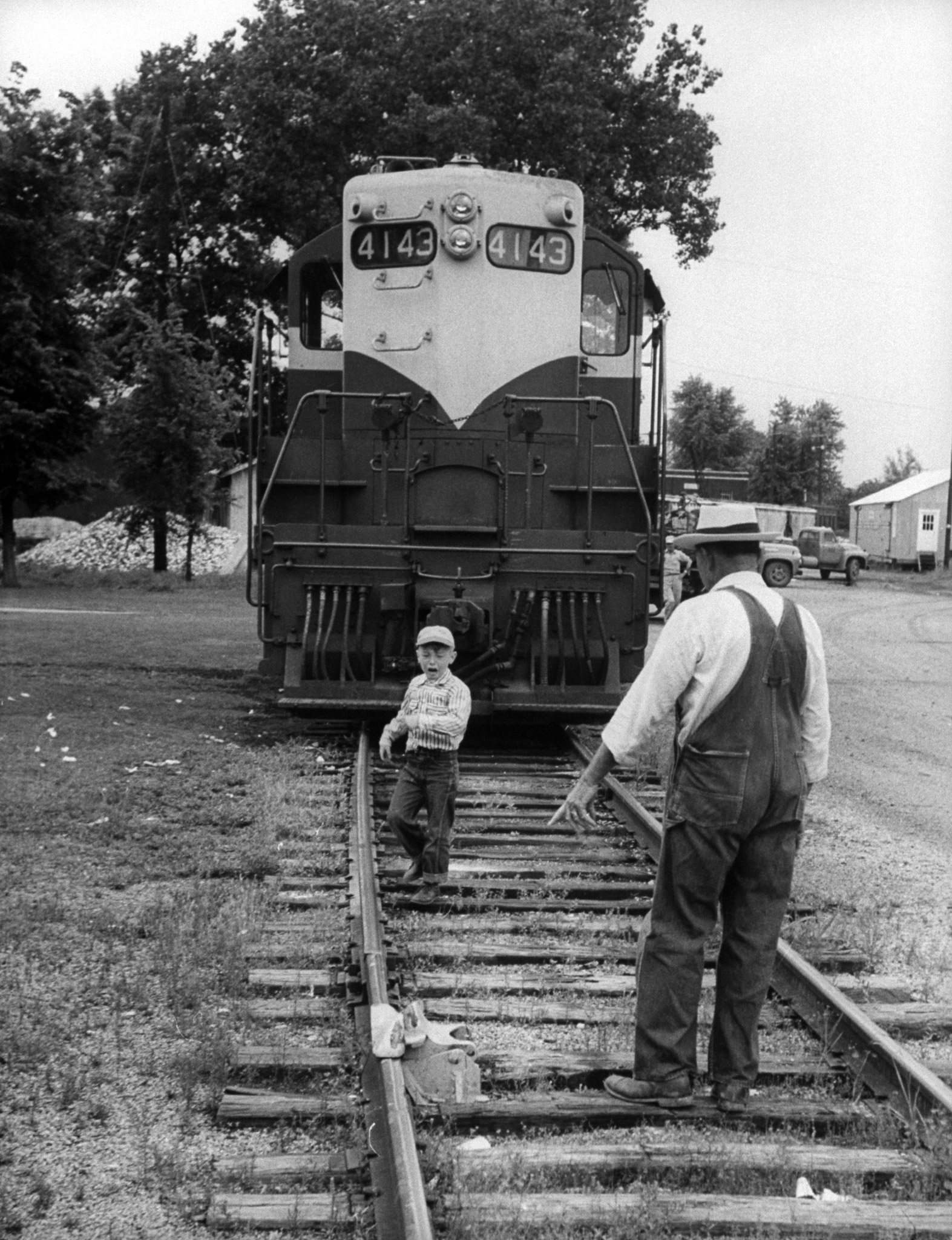Billy Conner talking to his grandfather William near a train.