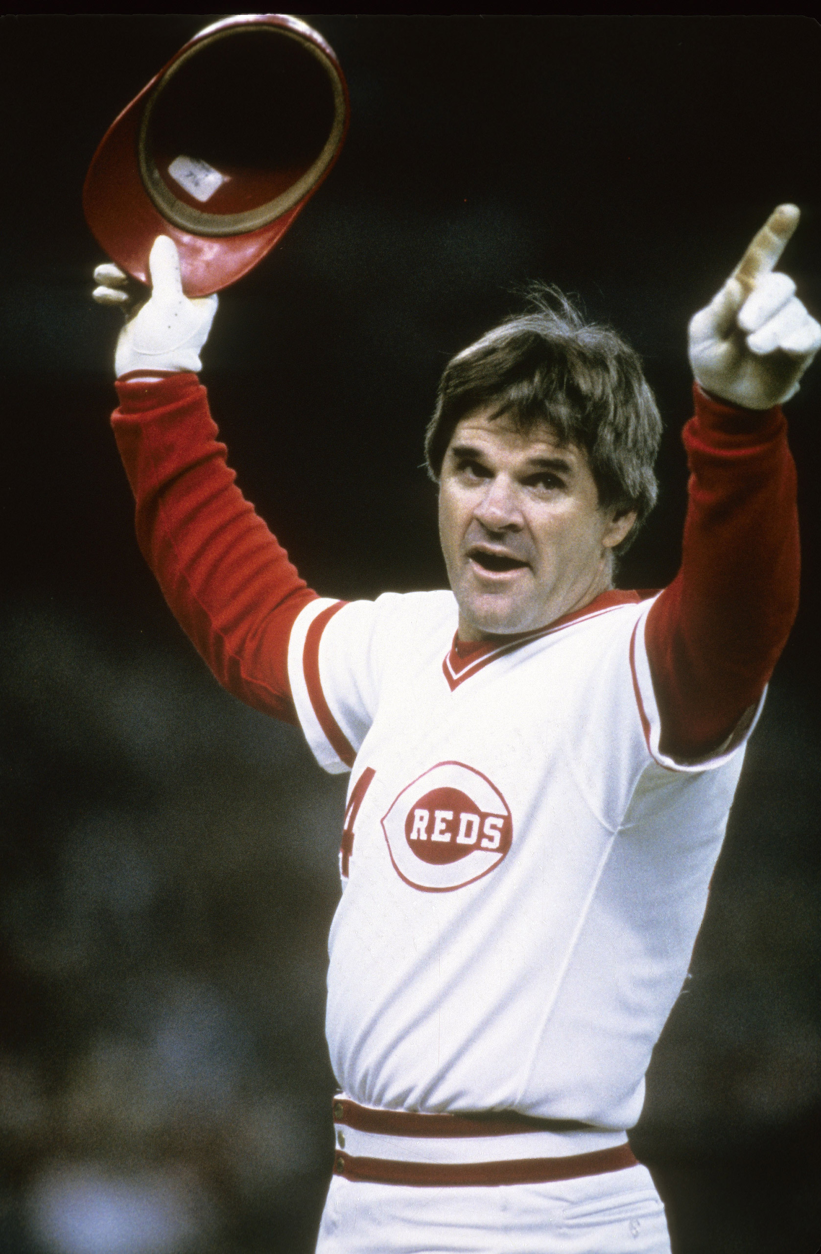 Outfielder Pete Rose #14 of the Cincinnati Reds salutes the crowd after surpassing Ty Cobb with his 4,192th hit that came against San Diego Padres pitcher Eric Show on Sept. 11, 1985, at Riverfront Stadium in Cincinnati, Ohio.
