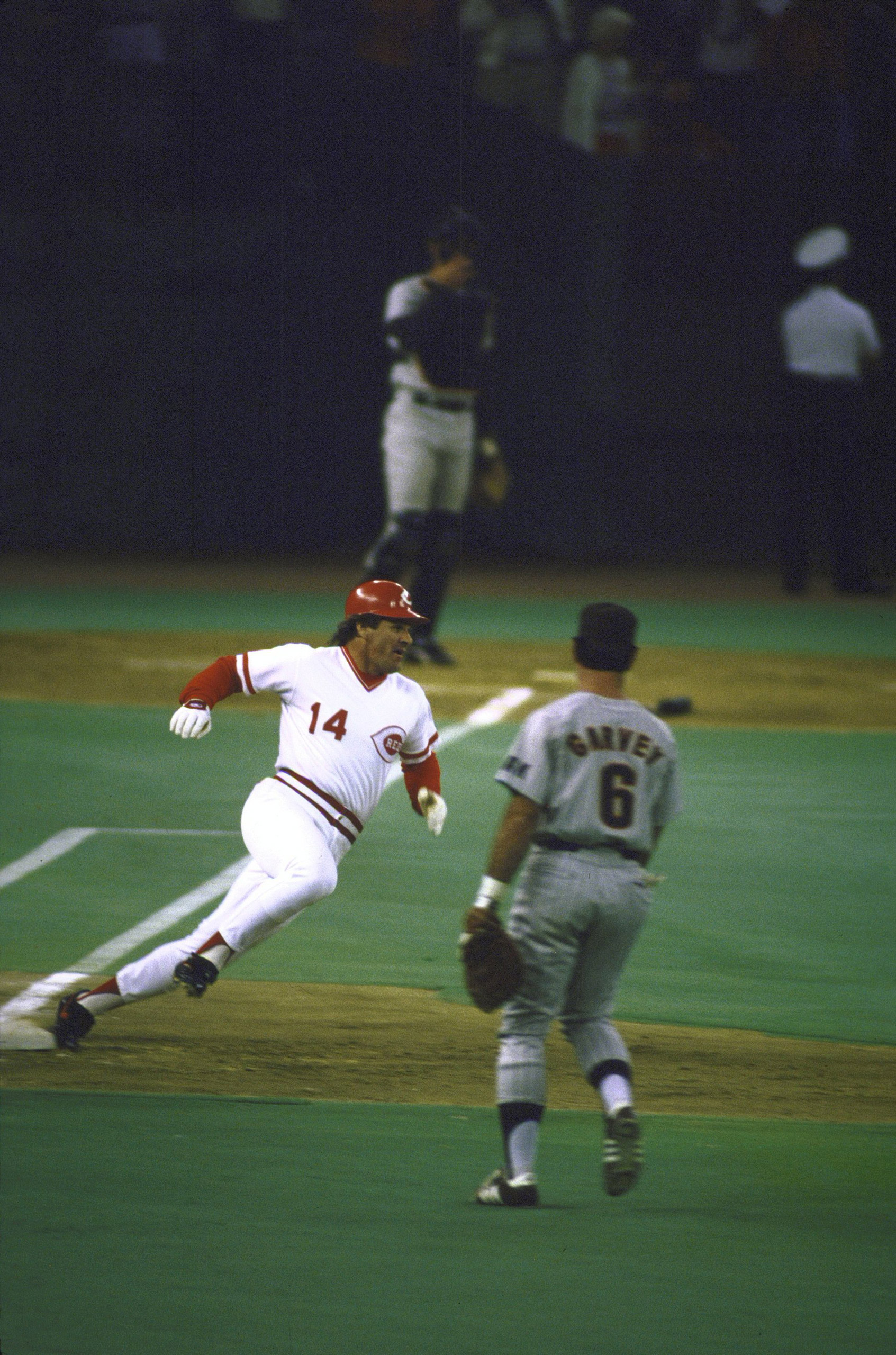 Cincinnati Reds Pete Rose (14) in action, rounding first base after setting hitting record with No. 4,192 career hit during game vs San Diego Padres.
