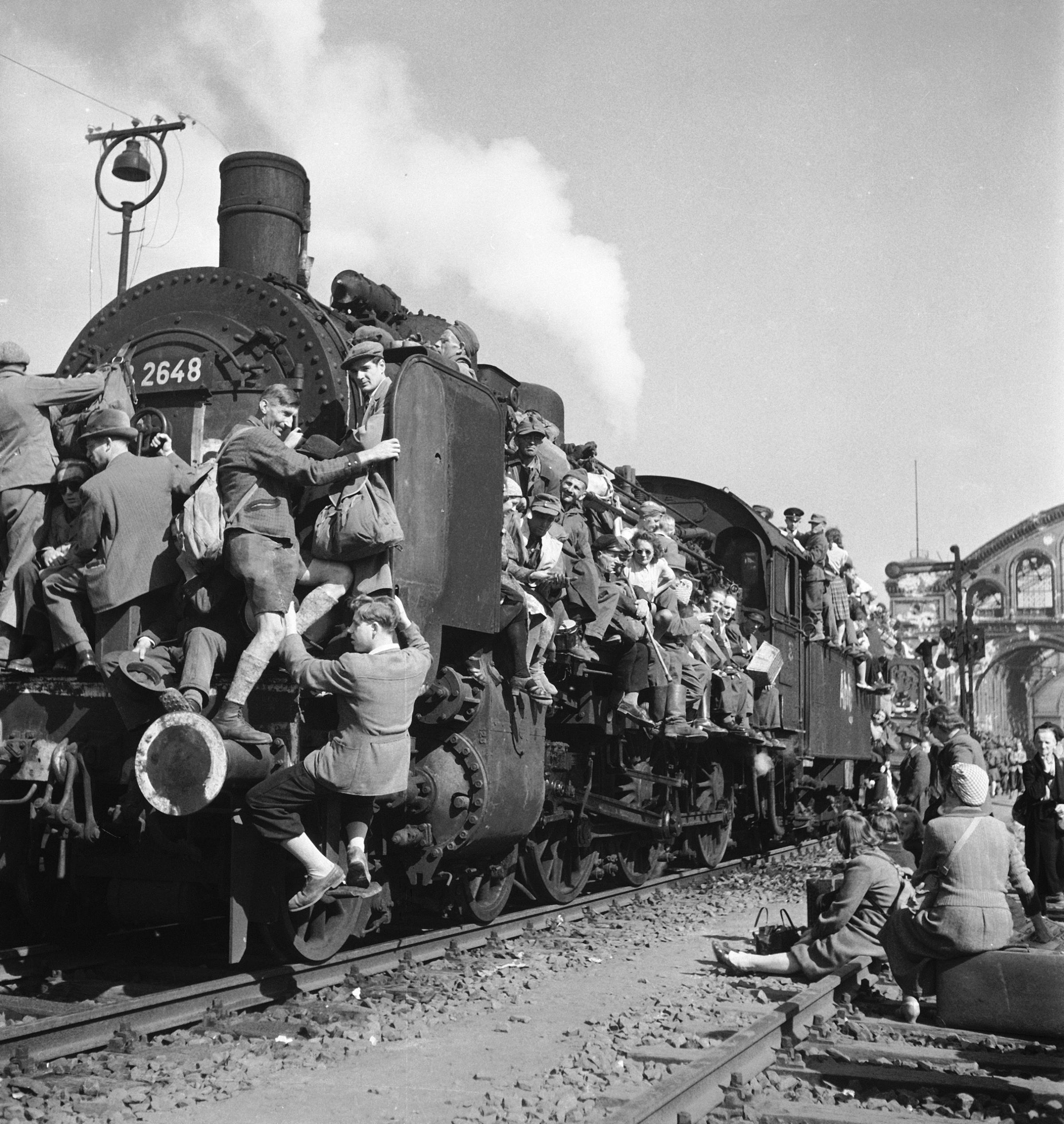 GERMANY - JUNE 06: Post WWII German refugees and displaced persons crowding every square inch of a train leaving Berlin. 1945.
