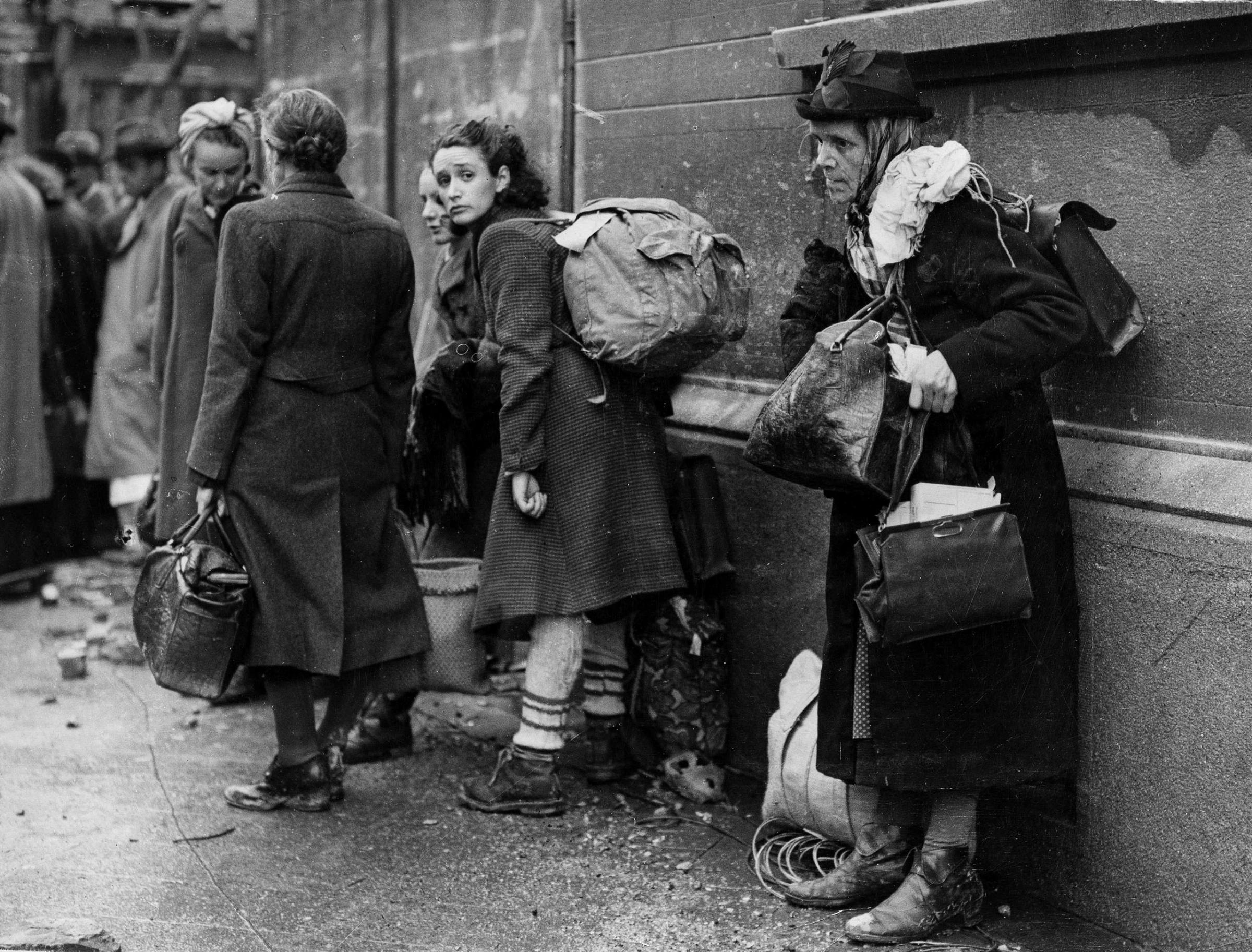 German civilian refugees prepare to flee war-torn Aachen, Germany as the battle for the doomed city draws to a close, Oct. 24, 1944. The refugees have been living in air-raid shelters as the battle for the city rages on. The Americans have about 4,000 of these refugees on their hands, who are being taken to a camp in Belgium and temporarily housed in a large school.