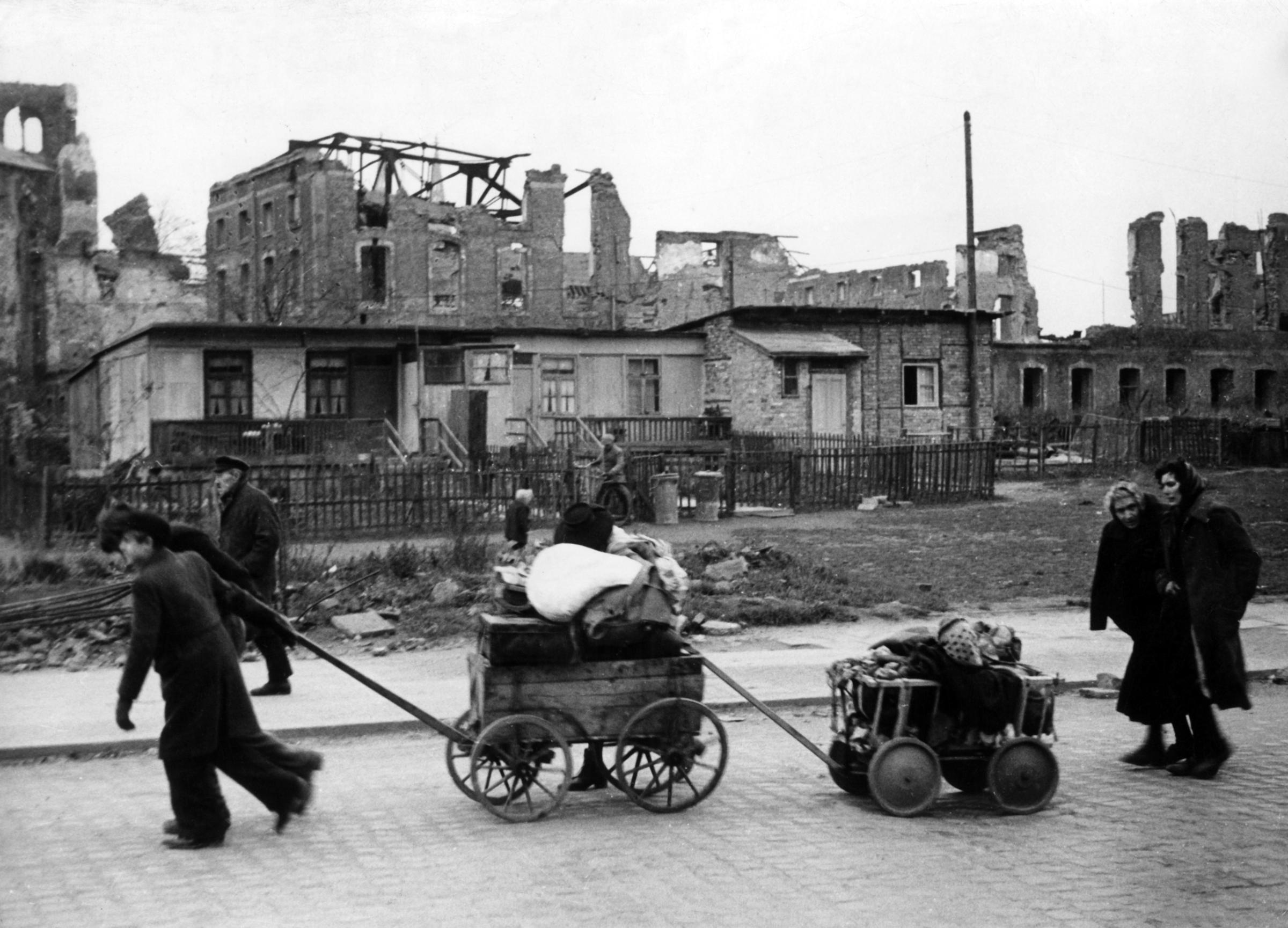 War refugees walking through Berlin with their whole belongings on 15th December 1945.