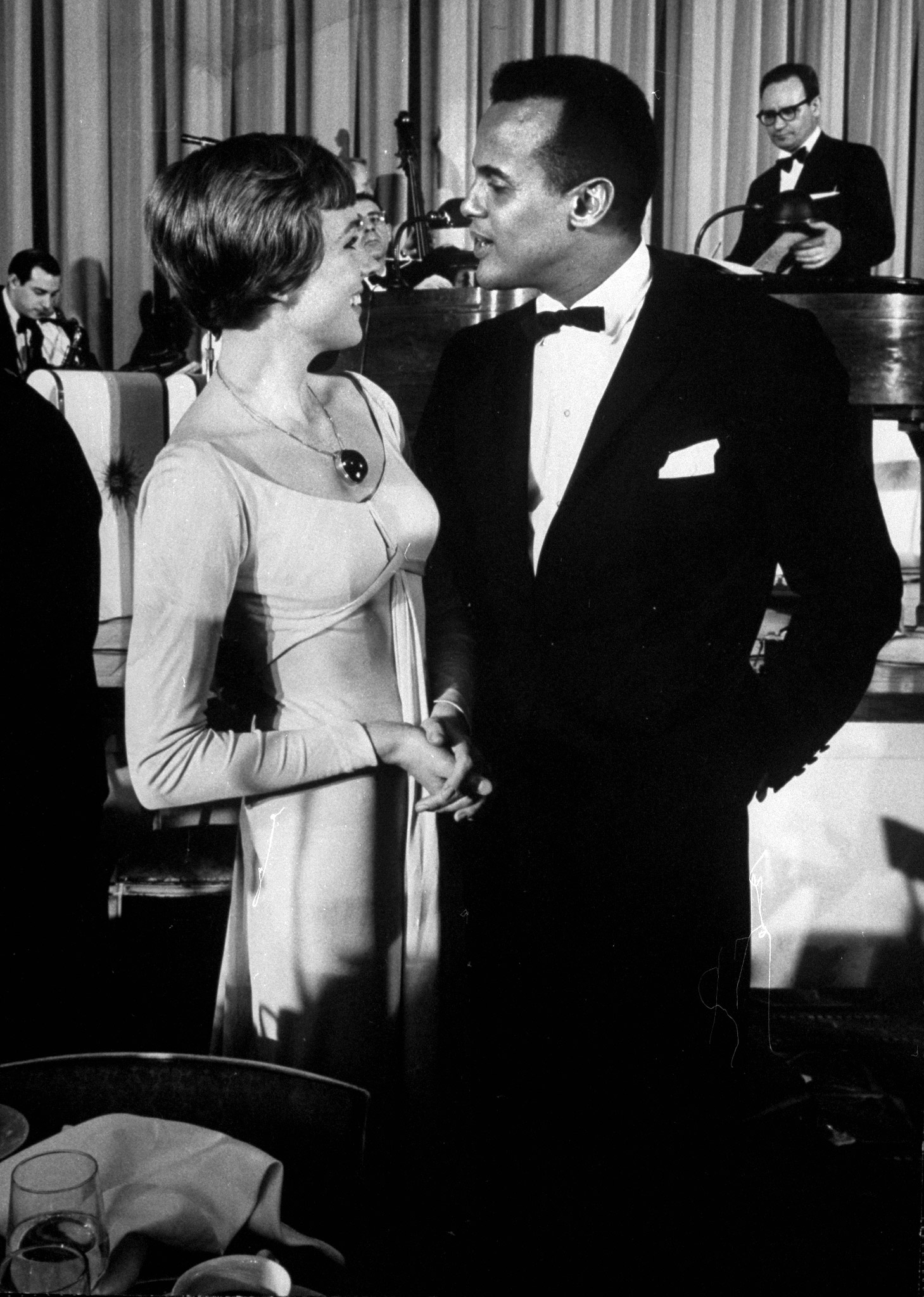 Singer Harry Belafonte with Julie Andrews at party following Broadway premiere of 'Sound of Music'.